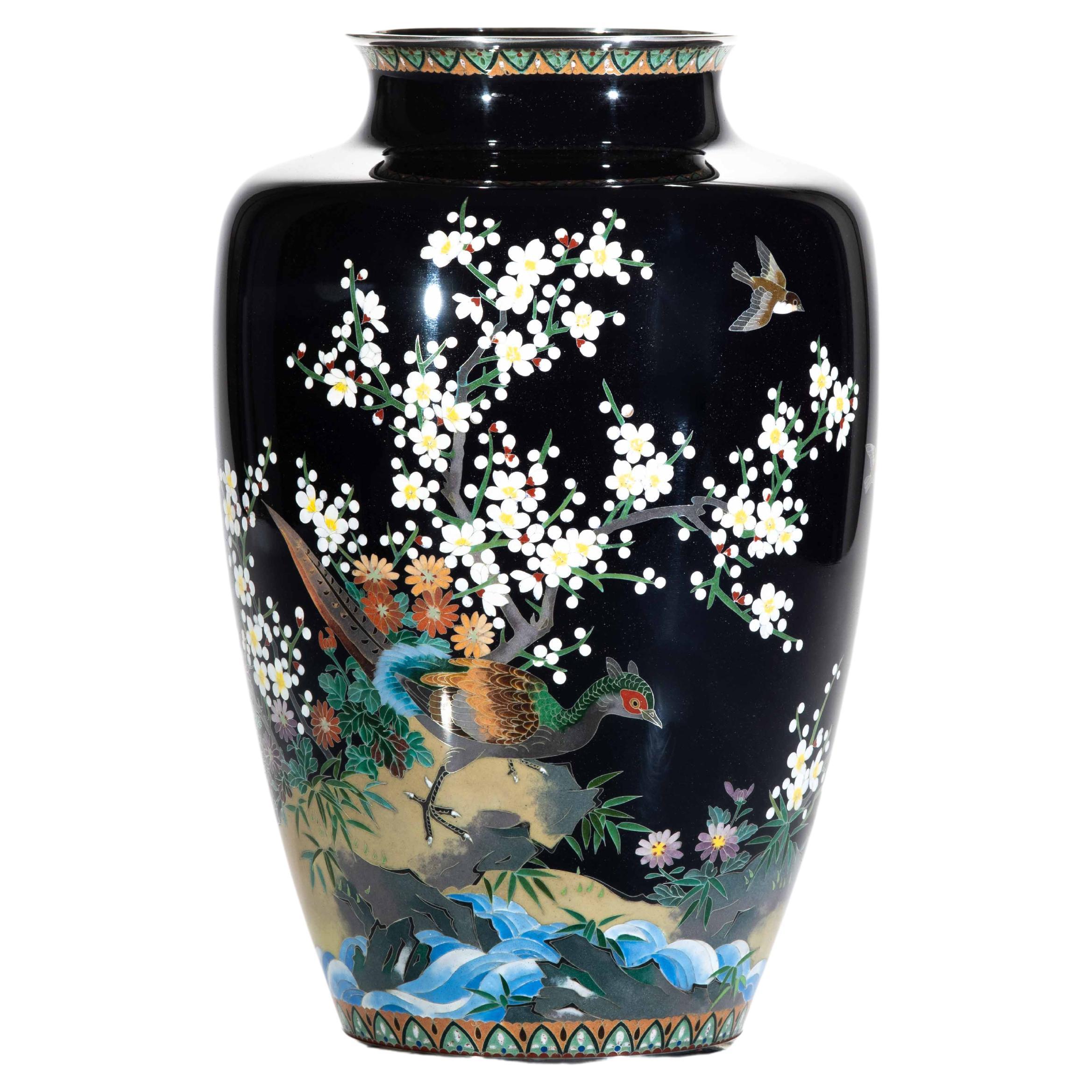 A cloisonné vase depicting a pheasant surrounded by blooming cherry
