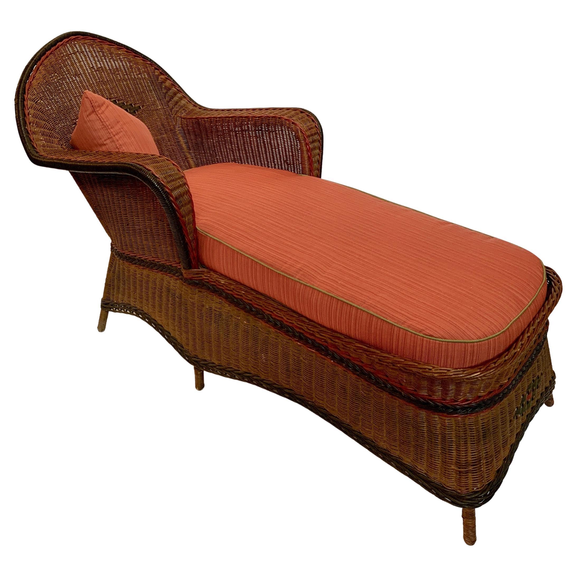 A grand sized close woven reed chaise lounge by the Heywood Wakefield Company of Gardner, Ma. C. 1920
This chaise is beautifully woven in a handsome natural finished reed and accented by woven paint decorated reeds in red, black and green.
The