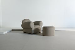 A Club Chair and Ottoman, Upholstered in Striped Fabric