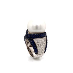 A Cocktail Pearl Ring of 34.30 Carats Surrounded with Blue Sapphires and diamond