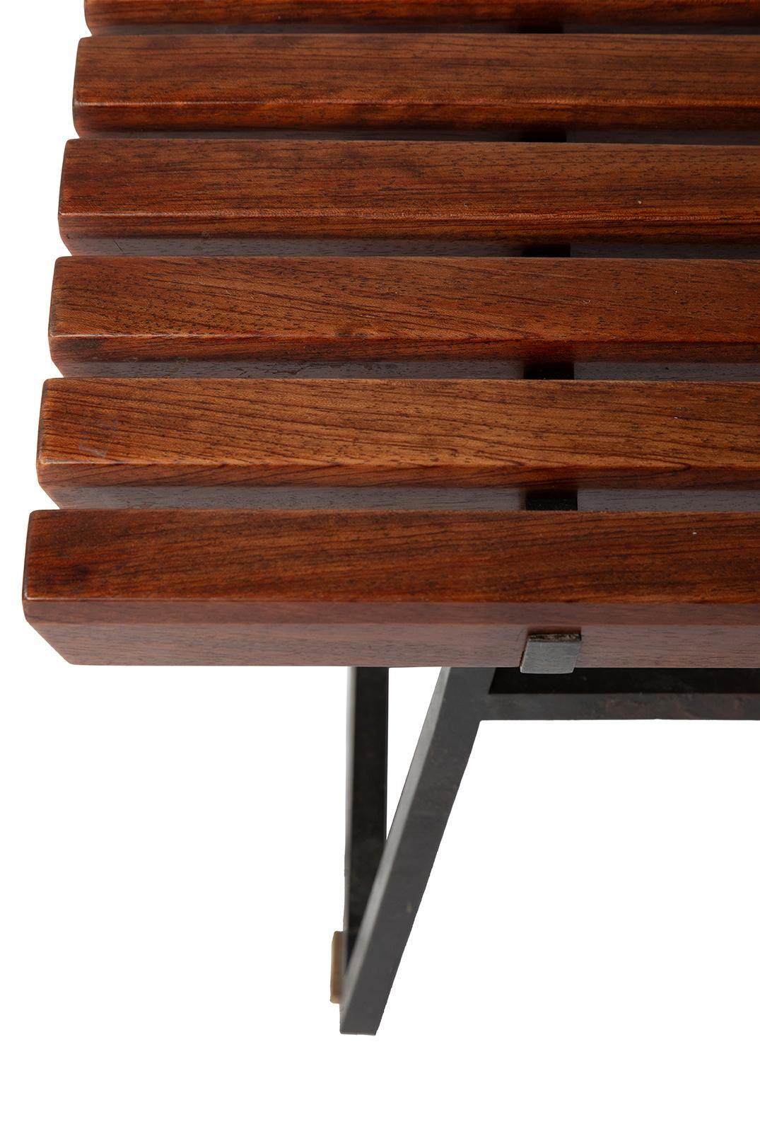 A fine low table with a blackened steel base on brass feet. The top is made with shaped bubinga battens with softened edges and hand polished.
