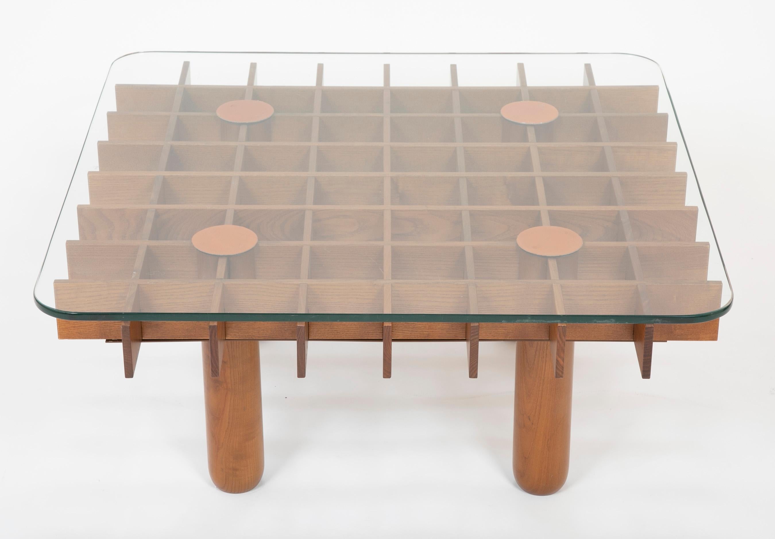 A grid form pine coffee table with leather pads and glass top. Designed by Fianfranco Frattini, produced for a short time by Knoll in 1974. Often called the Kyoto table although this is debatable because of its similarity in form and construction