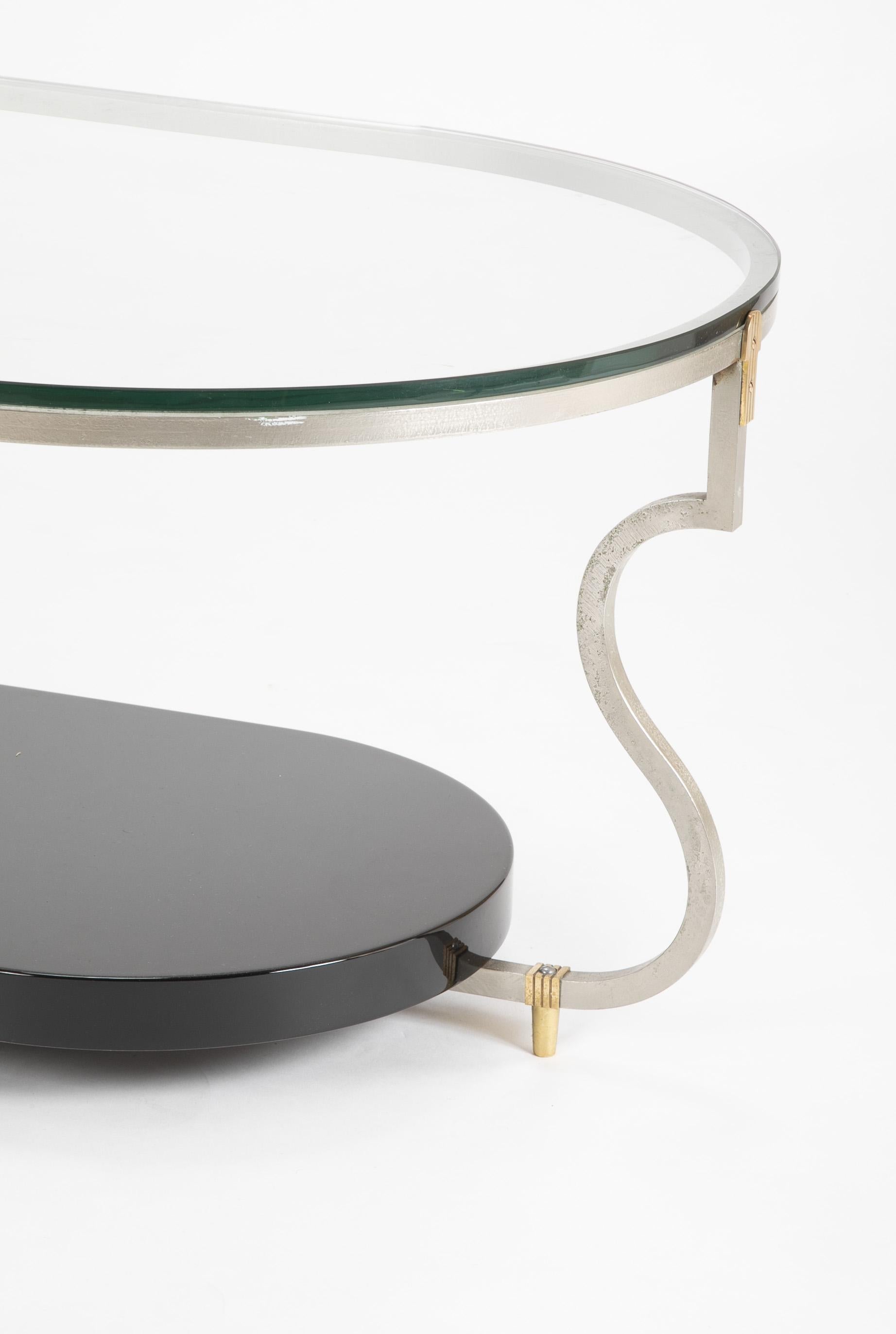 A black lacquer with glass, steel and brass coffee table designed by Tommi Parzinger. Fully restored.