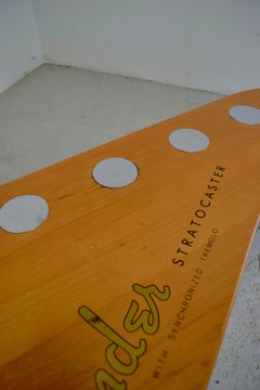 A coffee table in the shape of a Fender Stratocaster headstock 2000s
