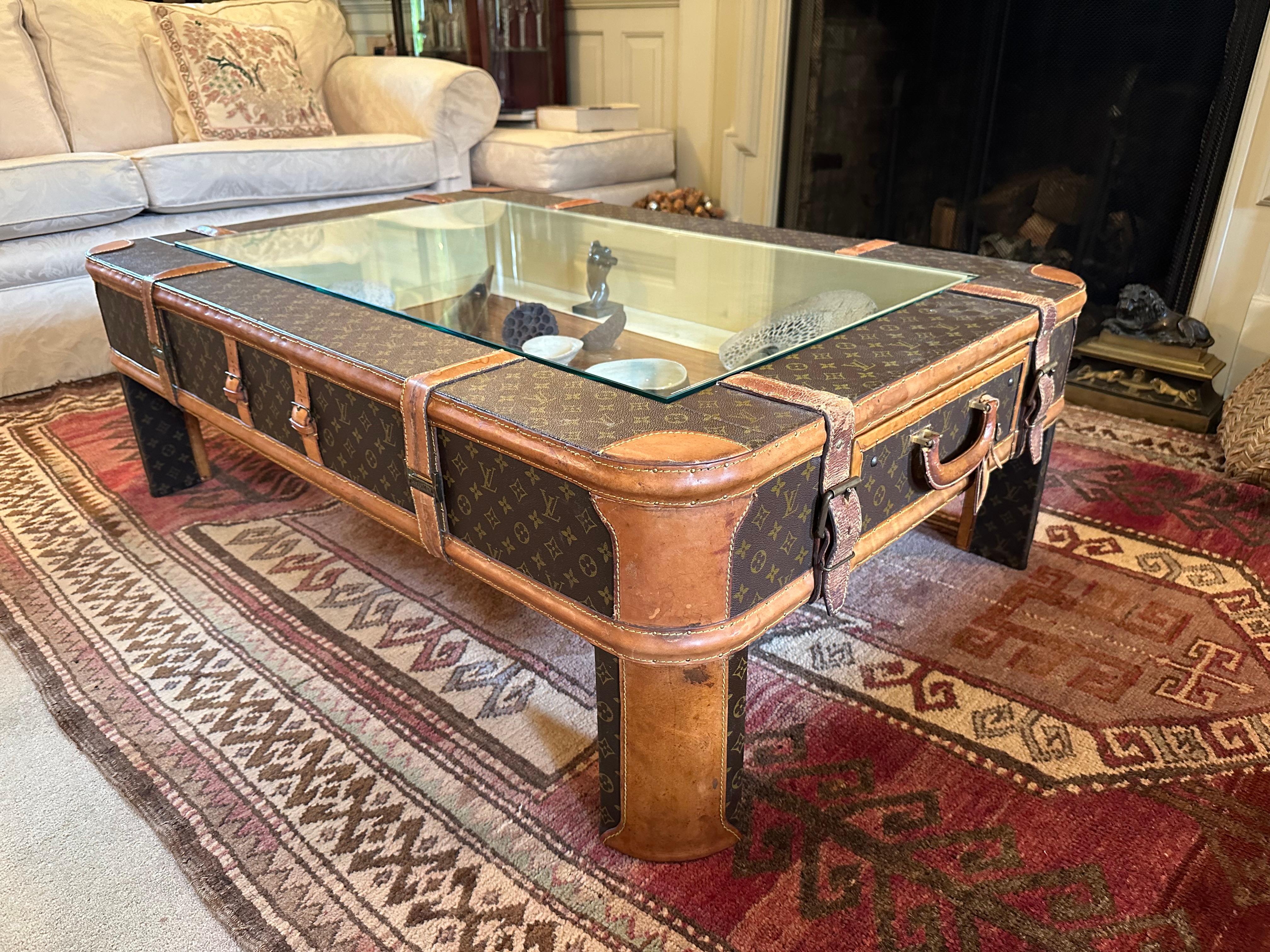 Indulge in the epitome of luxury with our bespoke Louis Vuitton coffee table, a striking fusion of heritage and contemporary design. Crafted from meticulously repurposed Louis Vuitton luggage dating back to the 1960s, this one-of-a-kind masterpiece