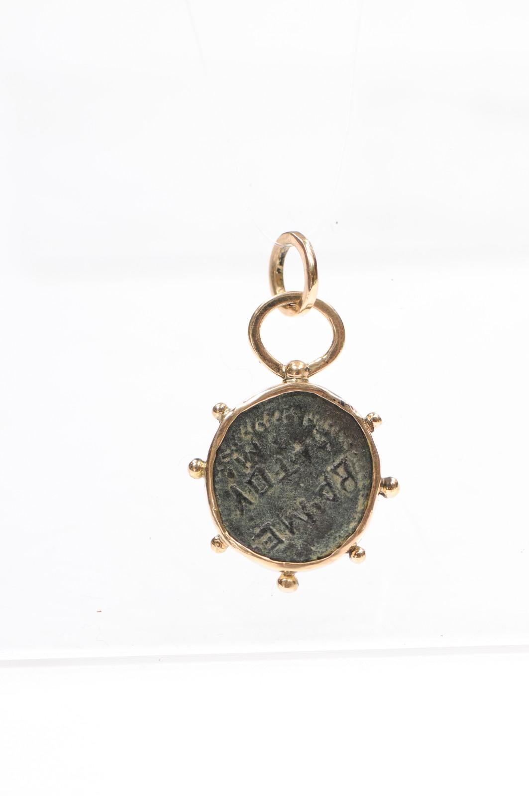 A coin from the reign of Mithridates III from the ancient kingdom of Commagene, circa 20-12 BC. It is 5 grams of bronze trimmed in18 karat gold. Commagene was a small mountain kingdom located in what was Asia Minor, in Eastern Anatolia, as a cushion