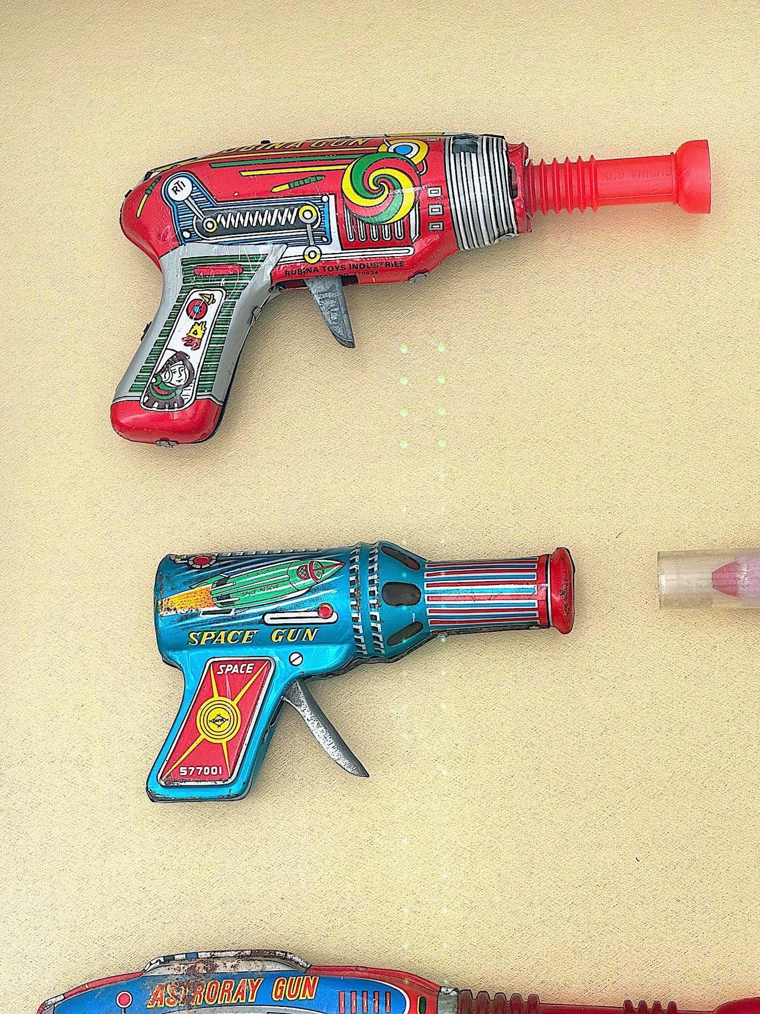 A collection of 1960s/70s tinplate and plastic ray guns mounted in a box frame. For Sale 3