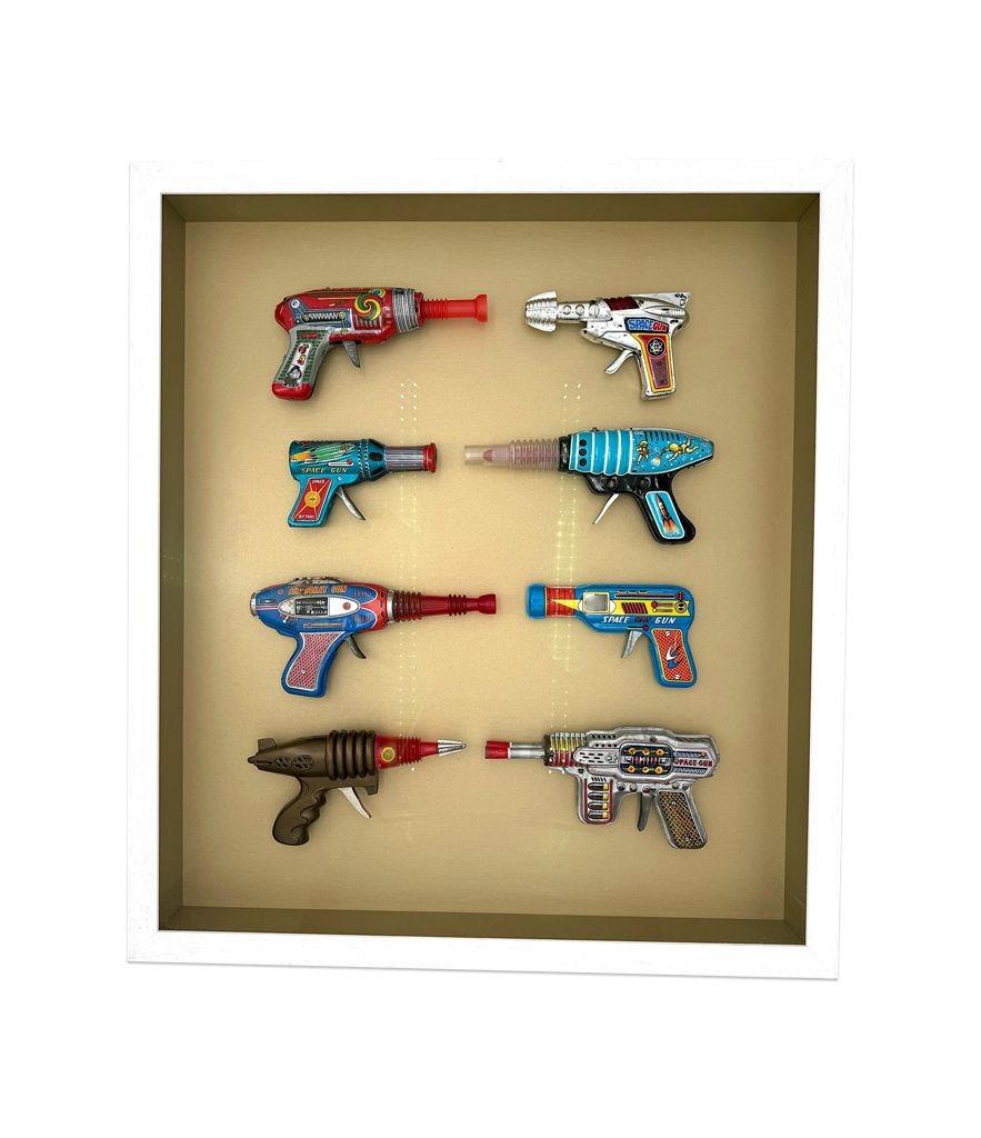Mid-Century Modern A collection of 1960s/70s tinplate and plastic ray guns mounted in a box frame. For Sale