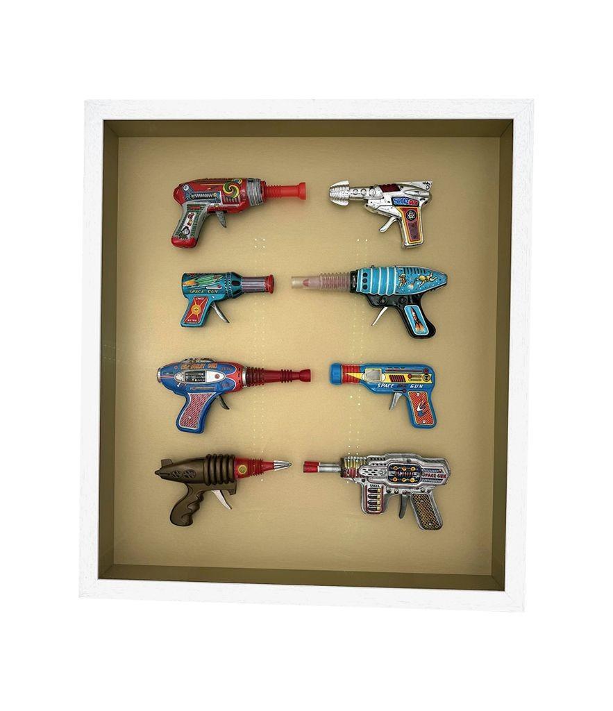 Mid-20th Century A collection of 1960s/70s tinplate and plastic ray guns mounted in a box frame. For Sale