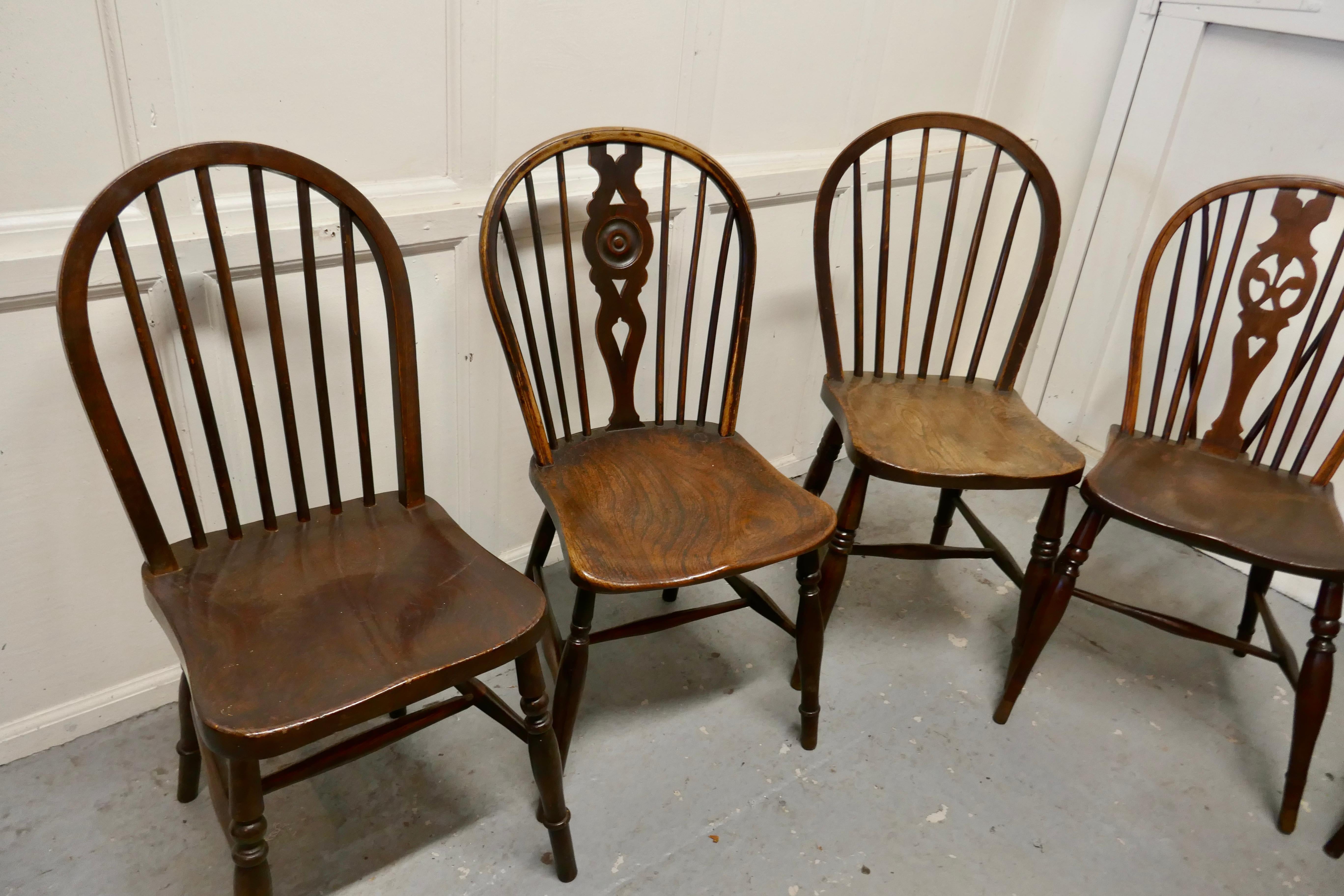 A Collection of 8 Beech and Elm Country Windsor Chairs

The chairs are a classic design and traditionally made from solid wood they all have hoop backs in the traditional Windsor style some with spindles the others are wheel back
 These chairs do