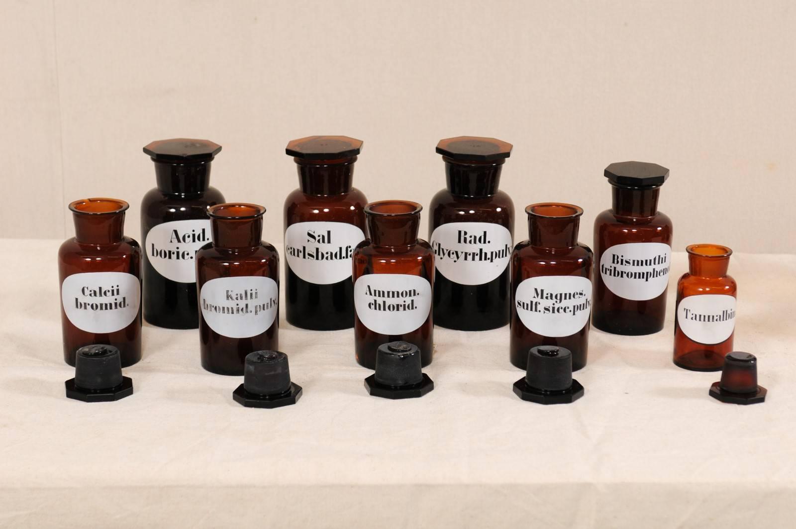 A collection of nine Swedish apothecary jars from the early 20th century. These antique jars from Sweden were once used to hold an apothecary's (or pharmacists) wares and chemicals. This wonderful set of nine jars, in varying sizes, are each made of