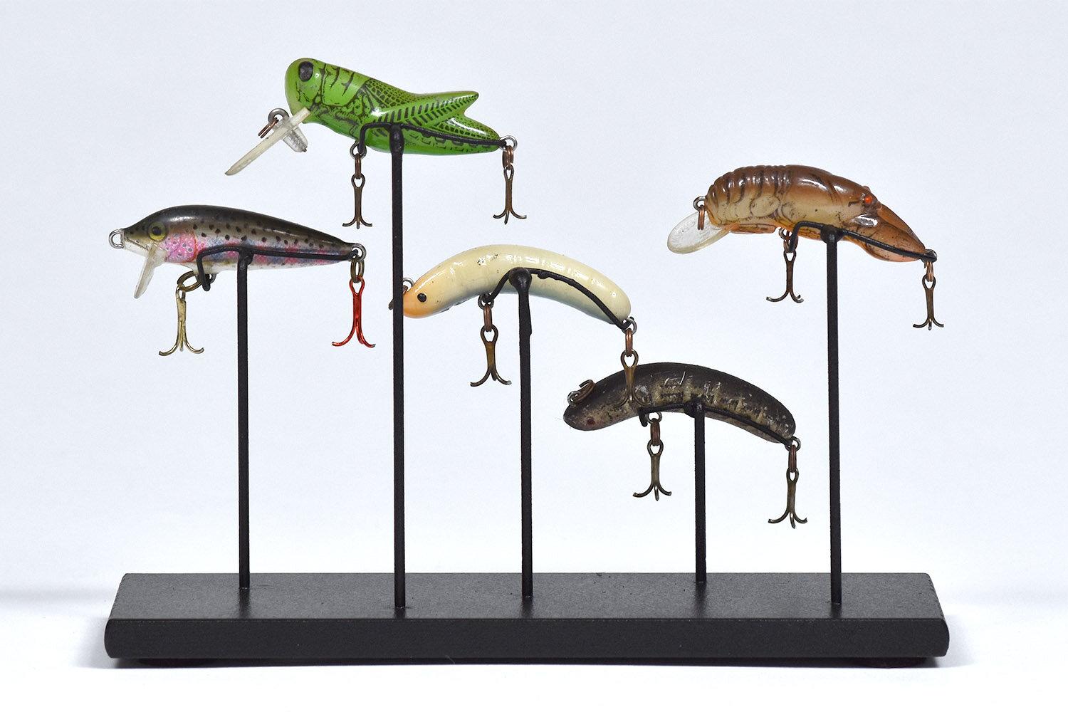 A collection of five vintage fishing lures

The age and condition of the lures vary and the hooks have been removed for safety. This whimsical collection evokes memories of being in nature and on vacation.

Mounted on a black painted steel base.