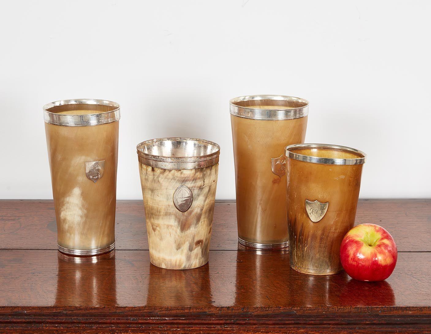 A rare collection of four generously sized 19th c. English horn hunting cups with sterling rims. One has a silvered lining. Each with a unique natural pattern on the horn.