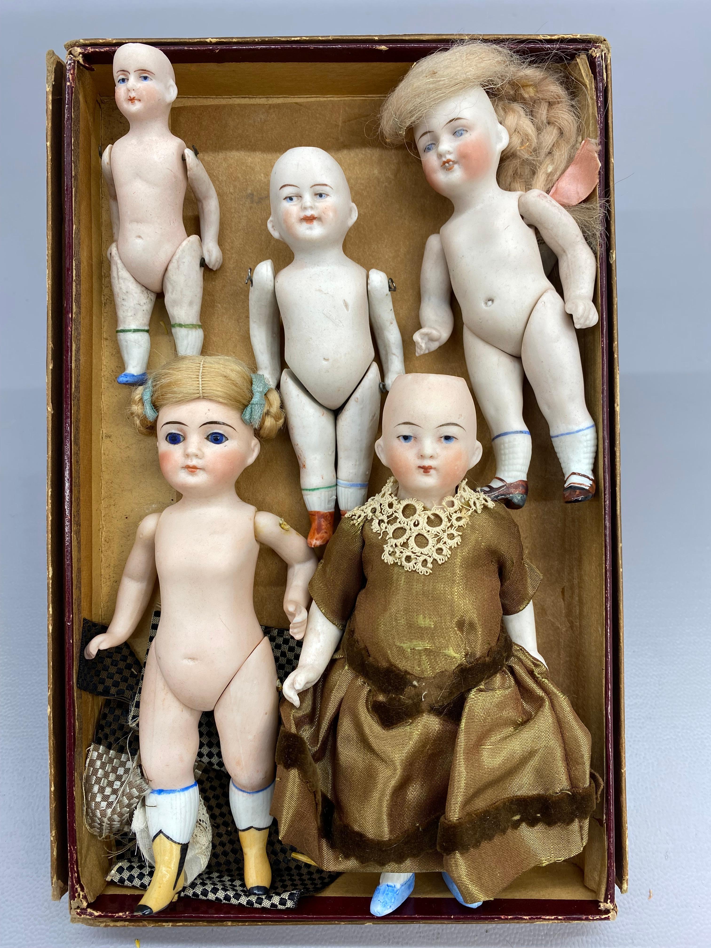 Five German/European bisque dolls. The largest doll measures approximately 1.13