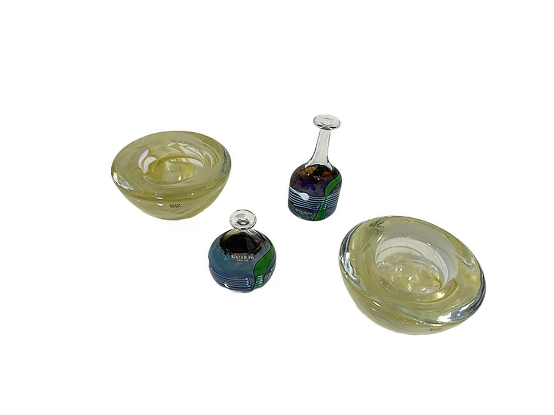A collection of Kosta Boda glass by Vallien and Ehrner, 1980-1990s.

4 items by Kosta Boda, Sweden, 1980s 2 miniature vases from Artist Boda collection by Bertil Vallien and 2 candleholders 