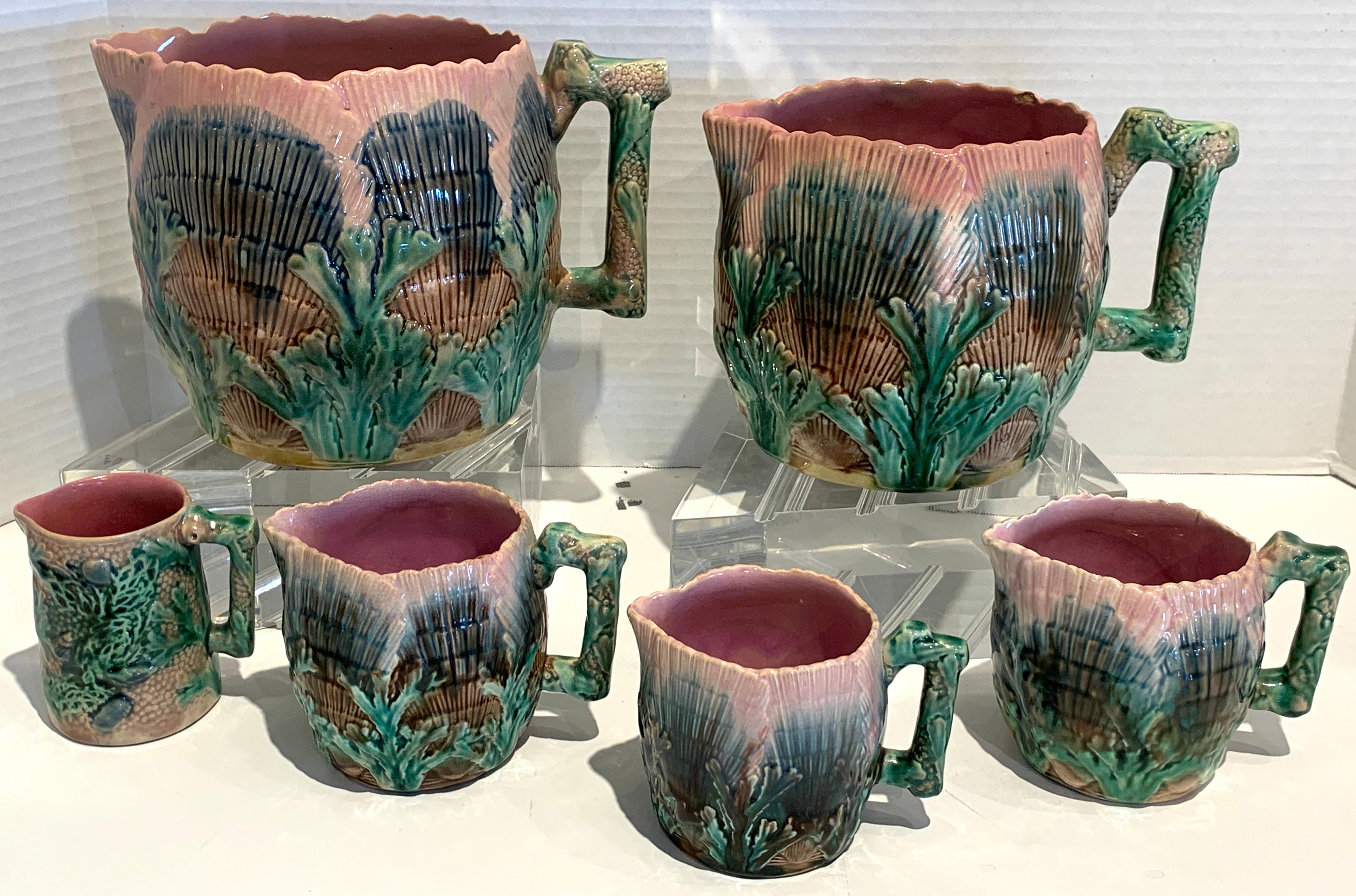 A collection of six Etruscan Majolica shell and seaweed pitchers, five in the typical shell and sea weed pattern, one in a variation of the pattern in the Narragansett style. A fine instant collection.
Pitcher #1 7