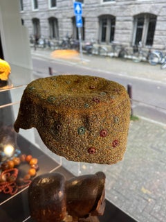 A collection of three embroidered Afghan hats