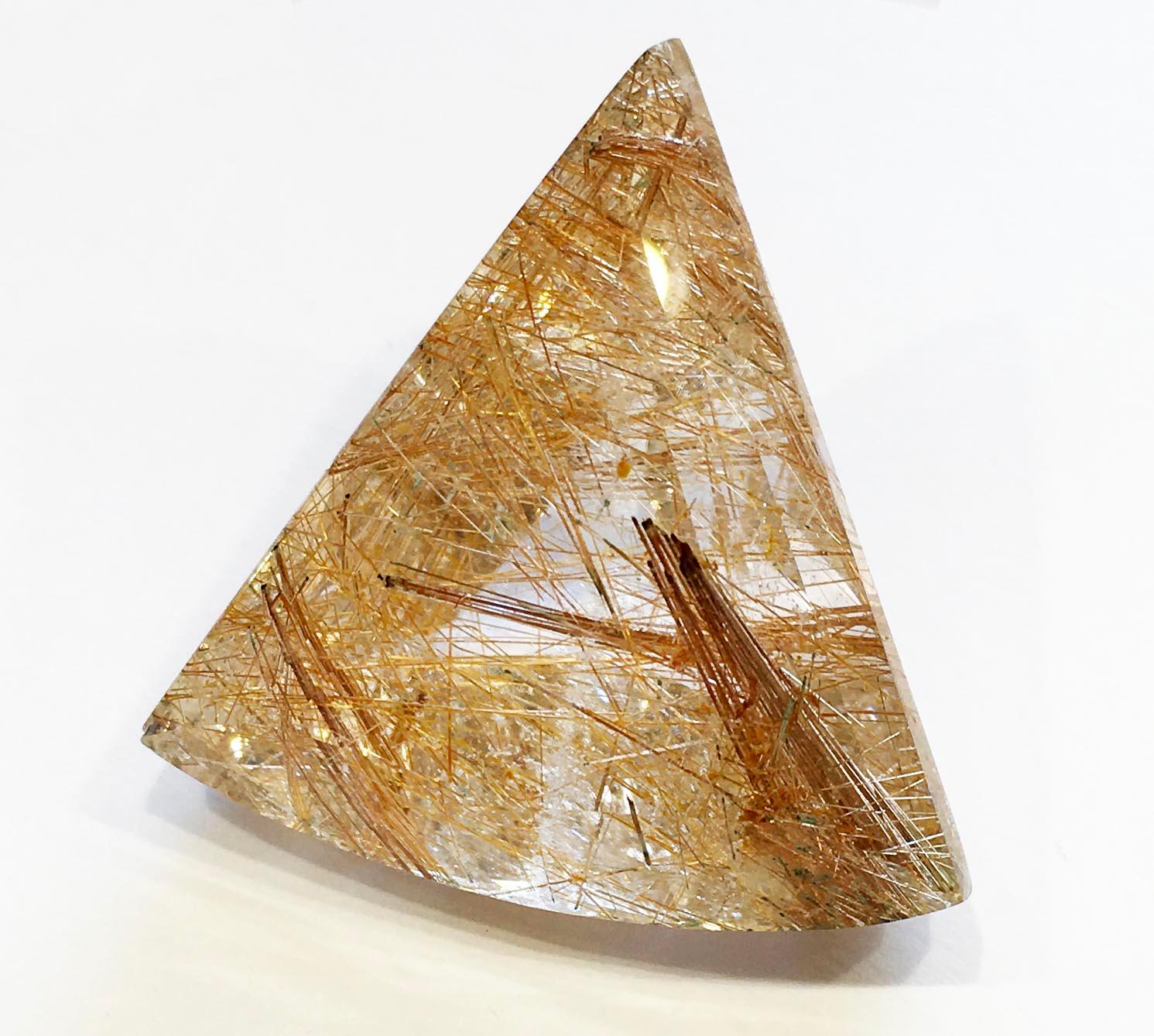 A Collectors Piece Triangle Cut Rutilated Quartz of 198.2 Carats. As pictured it is 1.75