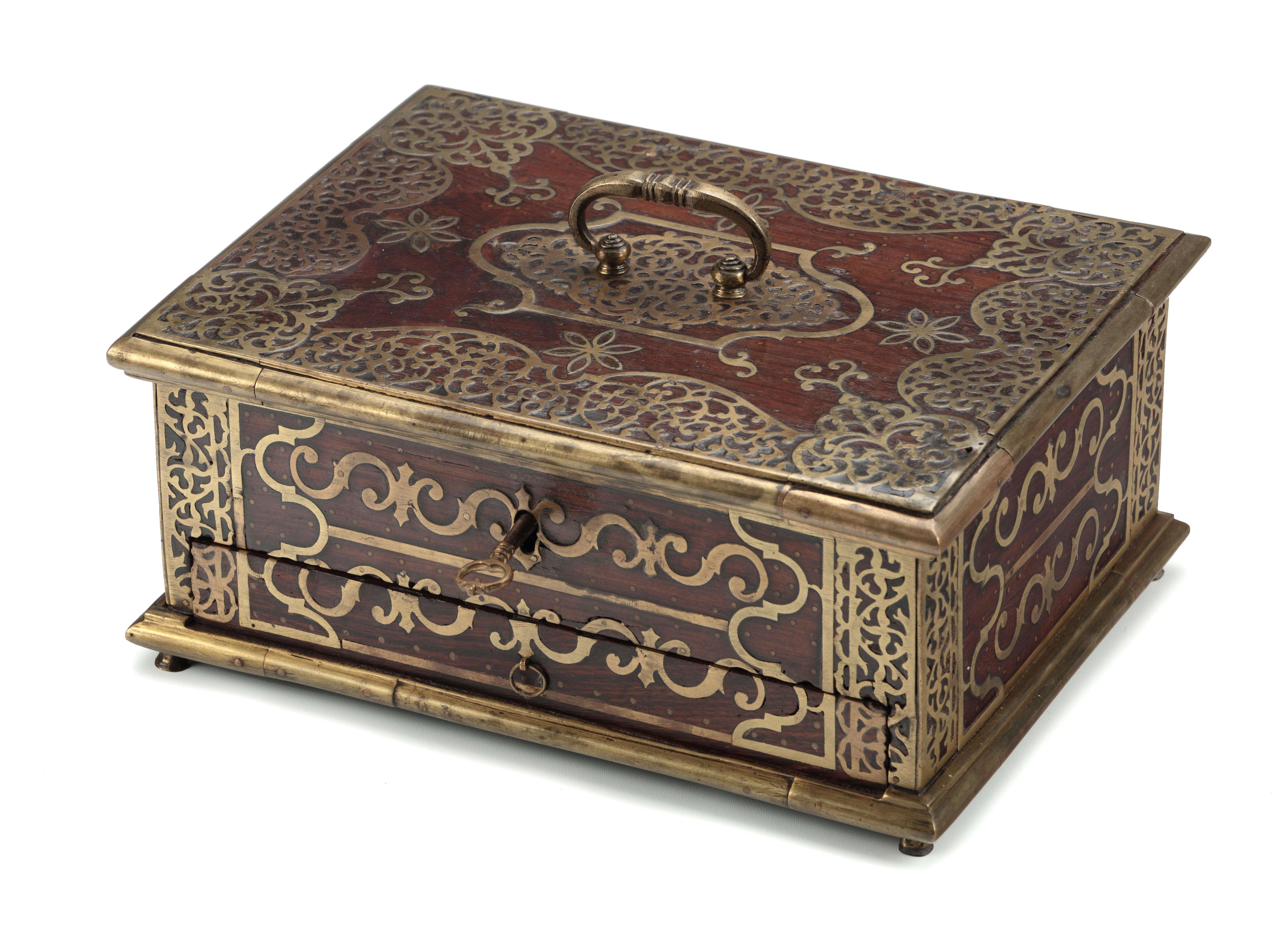 AN INDIAN ROSEWOOD AND EBONY BRASS MOUNTED BOX FOR THE ISLAMIC MARKET

 

Malabar Coast, 18th century
 

With a large drawer with several compartments under a lid with two compartment interior, with brass mounts and chased brass decoration,