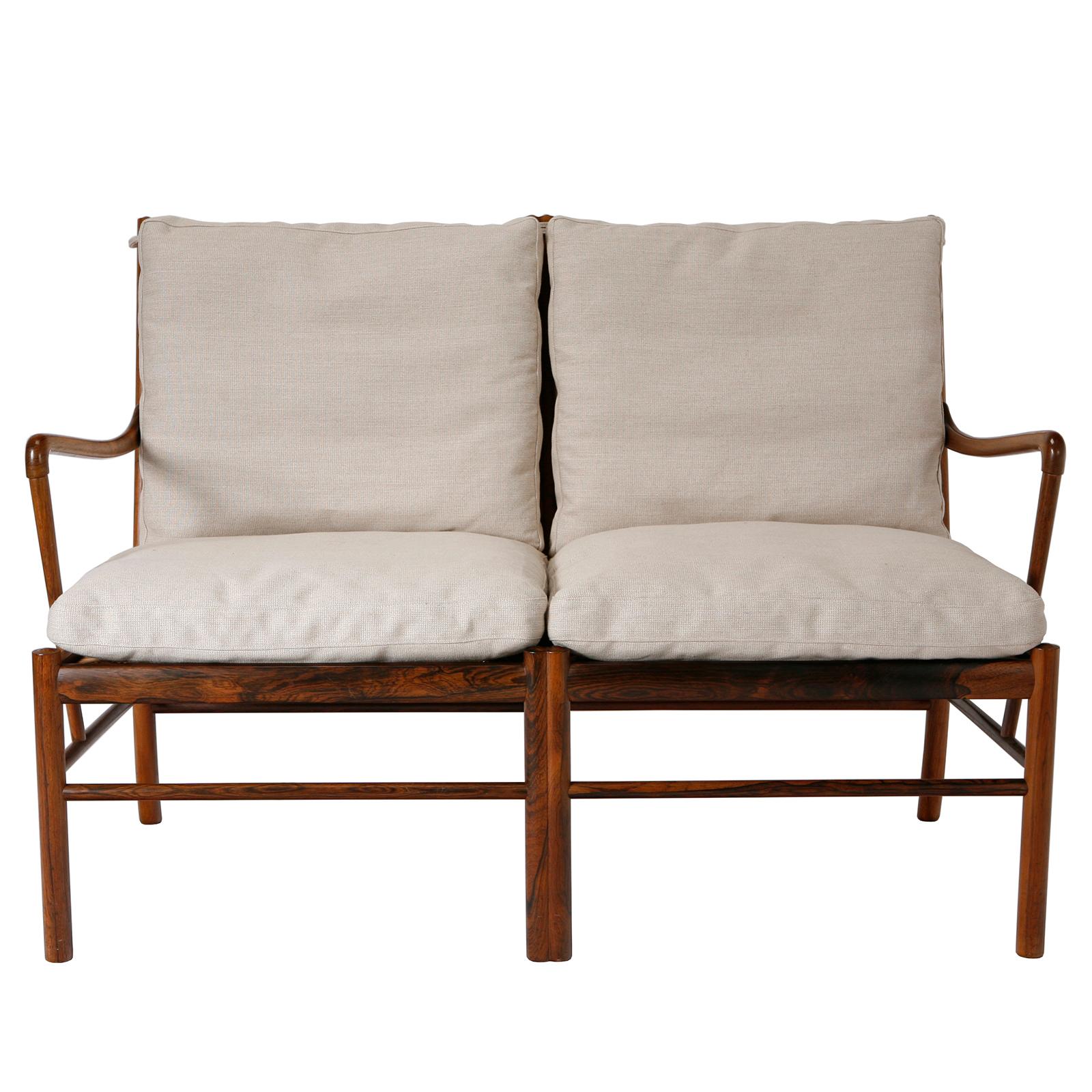 An early two-seat Colonial sofa in rosewood with loose down-filled cushions upholstered in new cream coloured textile. Designed in 1949 by Ole Wanscher, made by P. Jeppesen, Denmark.