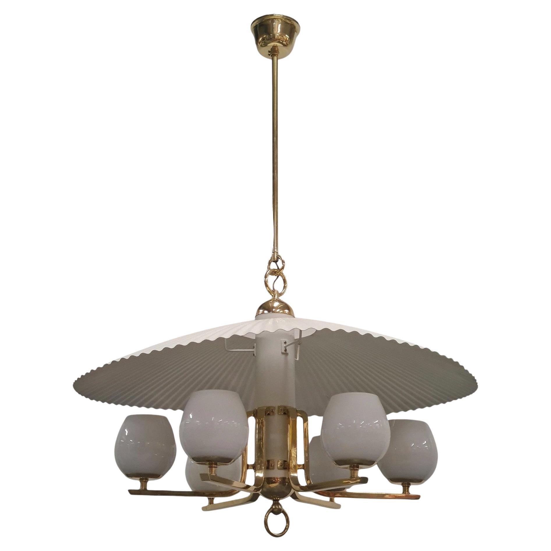 This is by far one of the most beautiful Tynell ceiling lamps we have come across in our 30 year career.

We believe this lamp is from the 1940s because of the style and the combination of materials used. Wood and sheet metal were much easier to