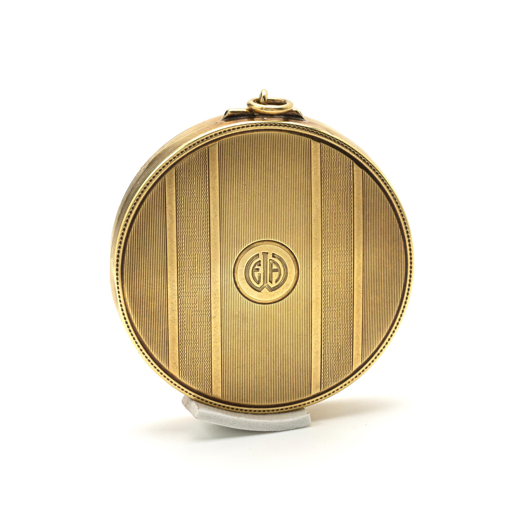 
A compact of textured gold patterns, opening to reveal a fitted mirror, of 14 karat yellow gold; stamped 14k.
1 3/4 inch diameter
weight 30 grams
