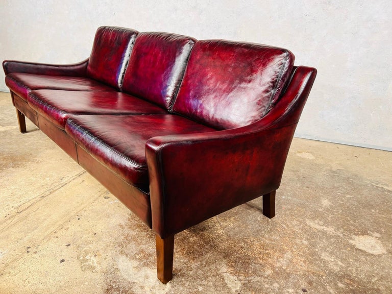 A Compact Vintage Danish 1970s Deep Red Three Seater Leather Sofa For