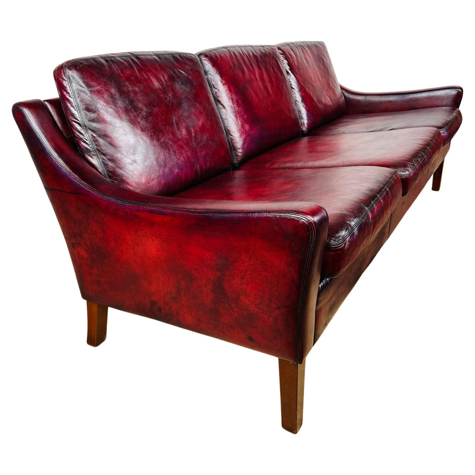 A Compact Vintage Danish 1970s Deep Red Three Seater Leather Sofa For Sale