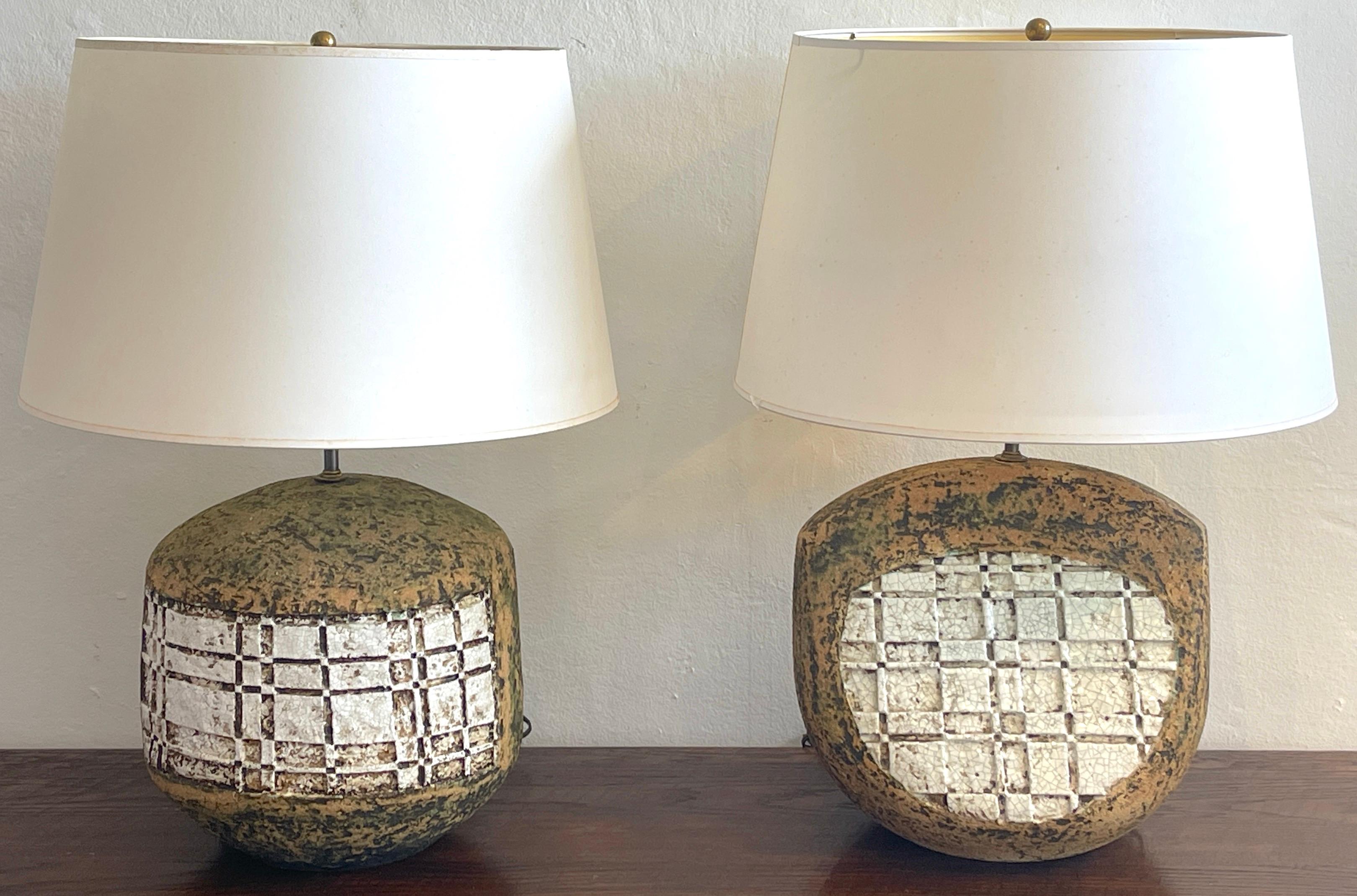 A companion pair Italian Mid-Century Modern pottery geometric lamps, one of circular and one a right triangular form, each one decorated with incised white glazed grid pattern on naturalistic background.
Shown with display 12