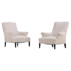 A companion pair of French Napoleon III upholstered lounge chairs C 1860.