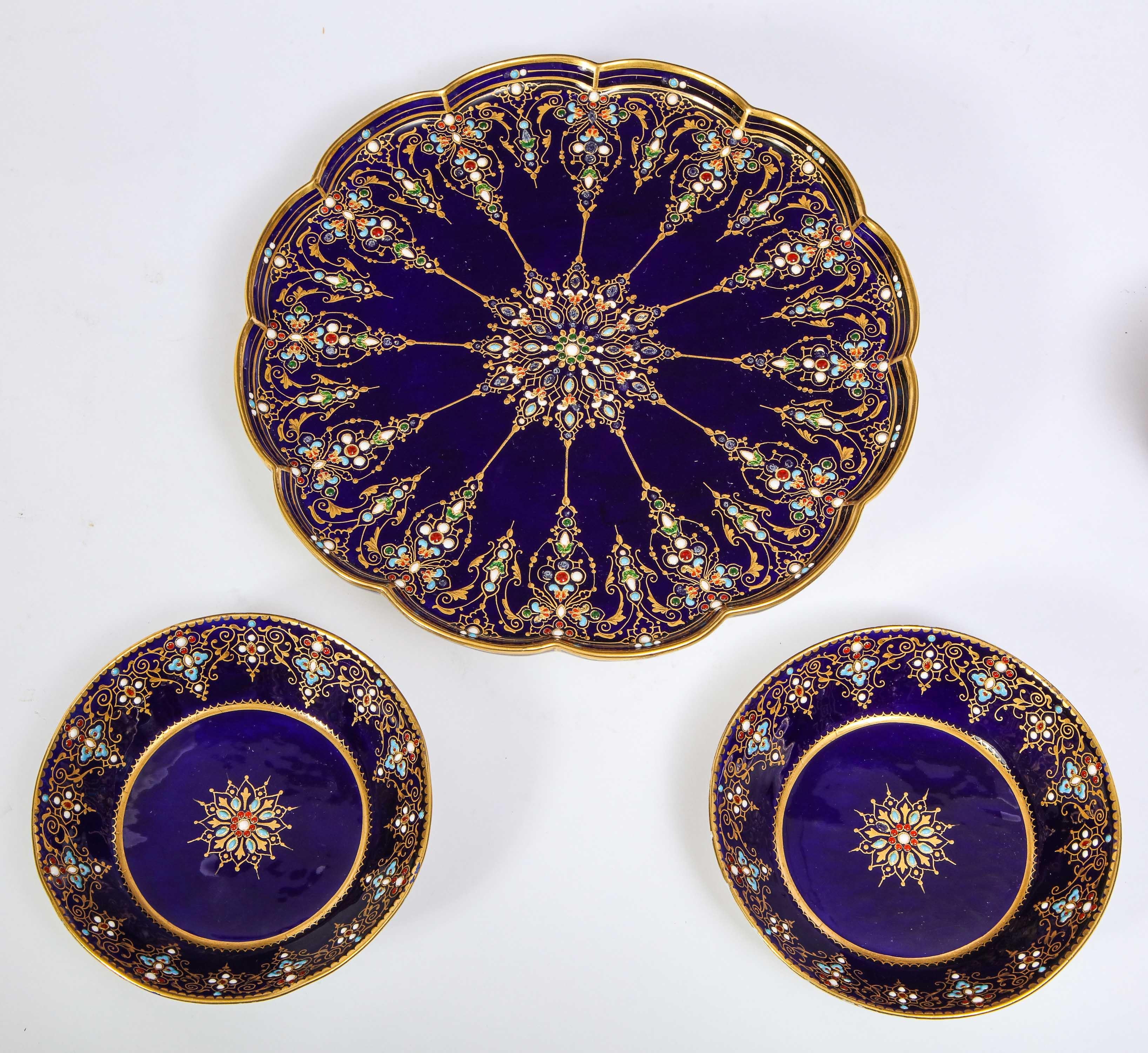 A magnificent and quite rare 19th century Louis XVI style Sevres Porcelain cobalt blue complete tea service (tête-à-tête), complete with two cups and saucers, tea pot, creamer, covered sugar, and serving platter. Each piece is finely decorated with