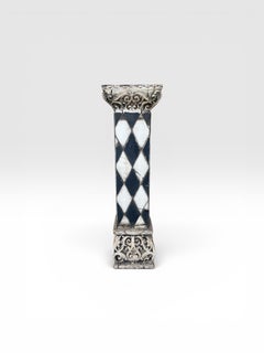 A Composition faux marble black and white harlequin patterned jardinere stand.