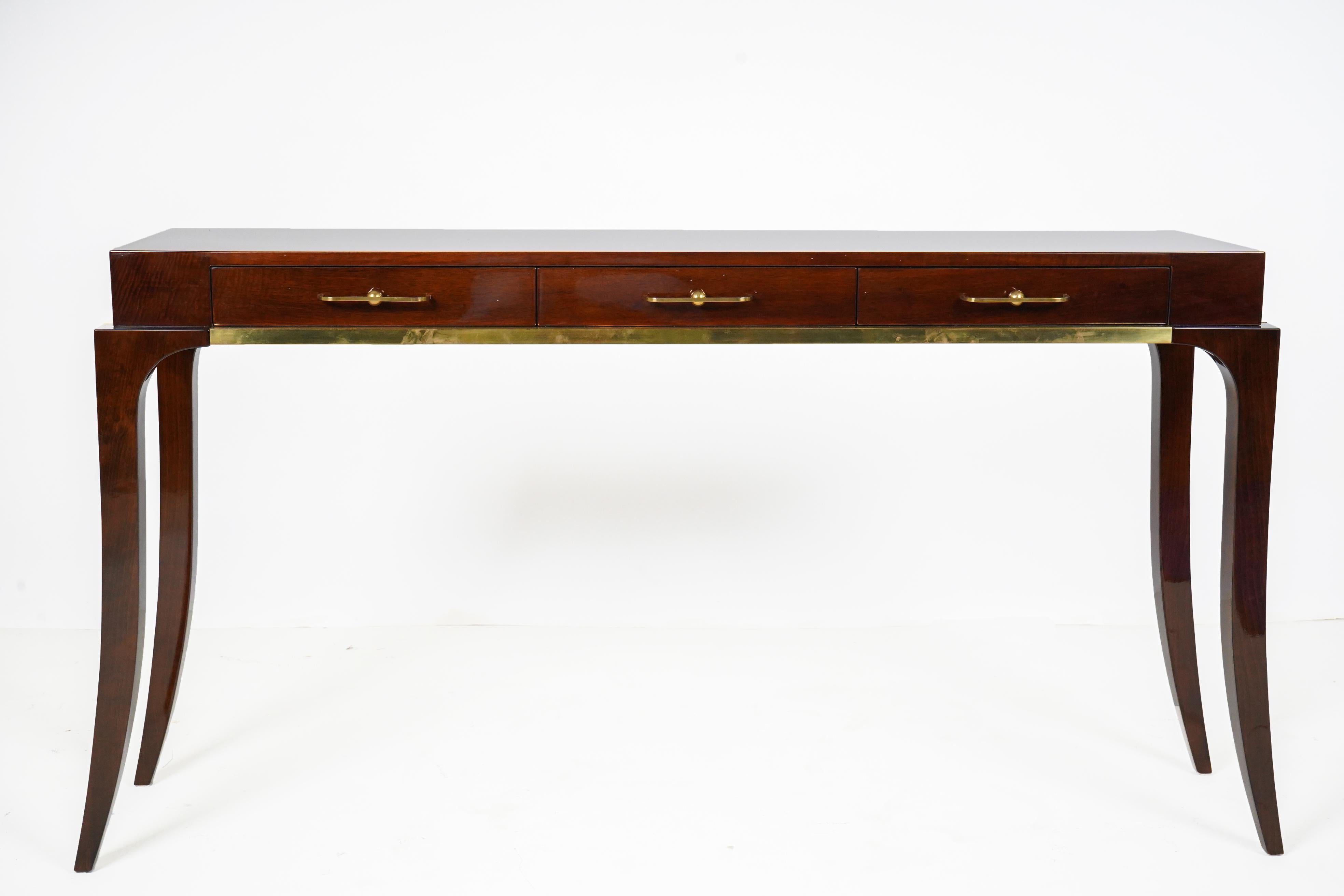 This Art Deco style console is based on vintage Hungarian designs from the 1930's. It is made from walnut veneers, solid walnut legs and solid brass handles and trim. The glossy finish is French polish. This is a particularly graceful console table,