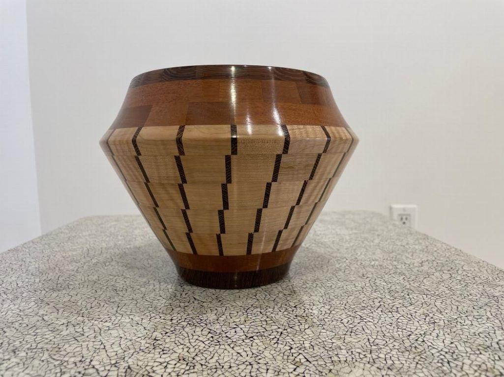 A contemporary turned wood bowl. Made of various marquetry and solid wood. Designed by John Enloth (signed )