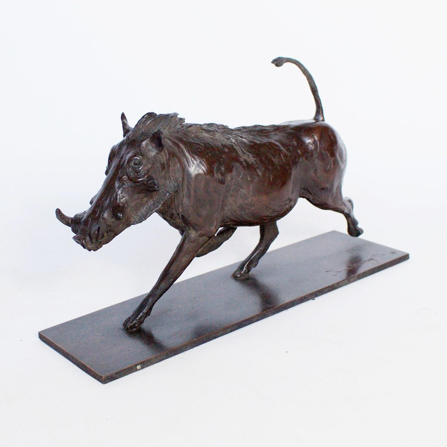 A Contemporary bronze sculpture of a trotting Warthog by Artist Jenna Gearing. Rich dark brown patination and fine hand finished detail. Limited edition 2/12. Signed Jenna Gearing to base. 

Jenna Gearing is a contemporary sculptor who's interest