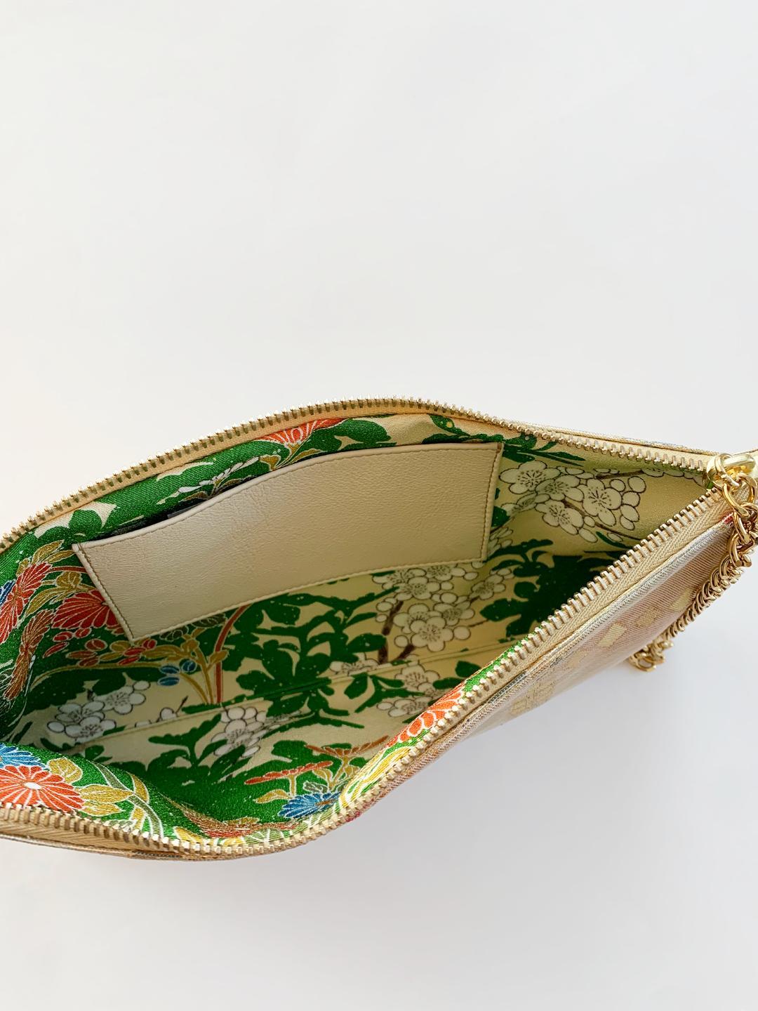 •	Made from precious vintage Japanese brocade from Kyoto. One of only three made.
•	29cm long  x 14cm high x 2 cm wide
•	22ct gold plated Wristlet Chain drop 16cm, fixed to the zip..
•	Lined in matching vintage Japanese silk with an open card