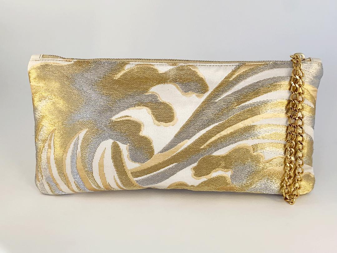 •	Made from precious vintage Japanese brocade from Kyoto. One of only three made.
•	29cm long  x 14cm high x 2 cm wide
•	22ct gold plated Wristlet Chain drop 16cm, fixed to the zip..
•	Lined in matching vintage Japanese silk with an open card