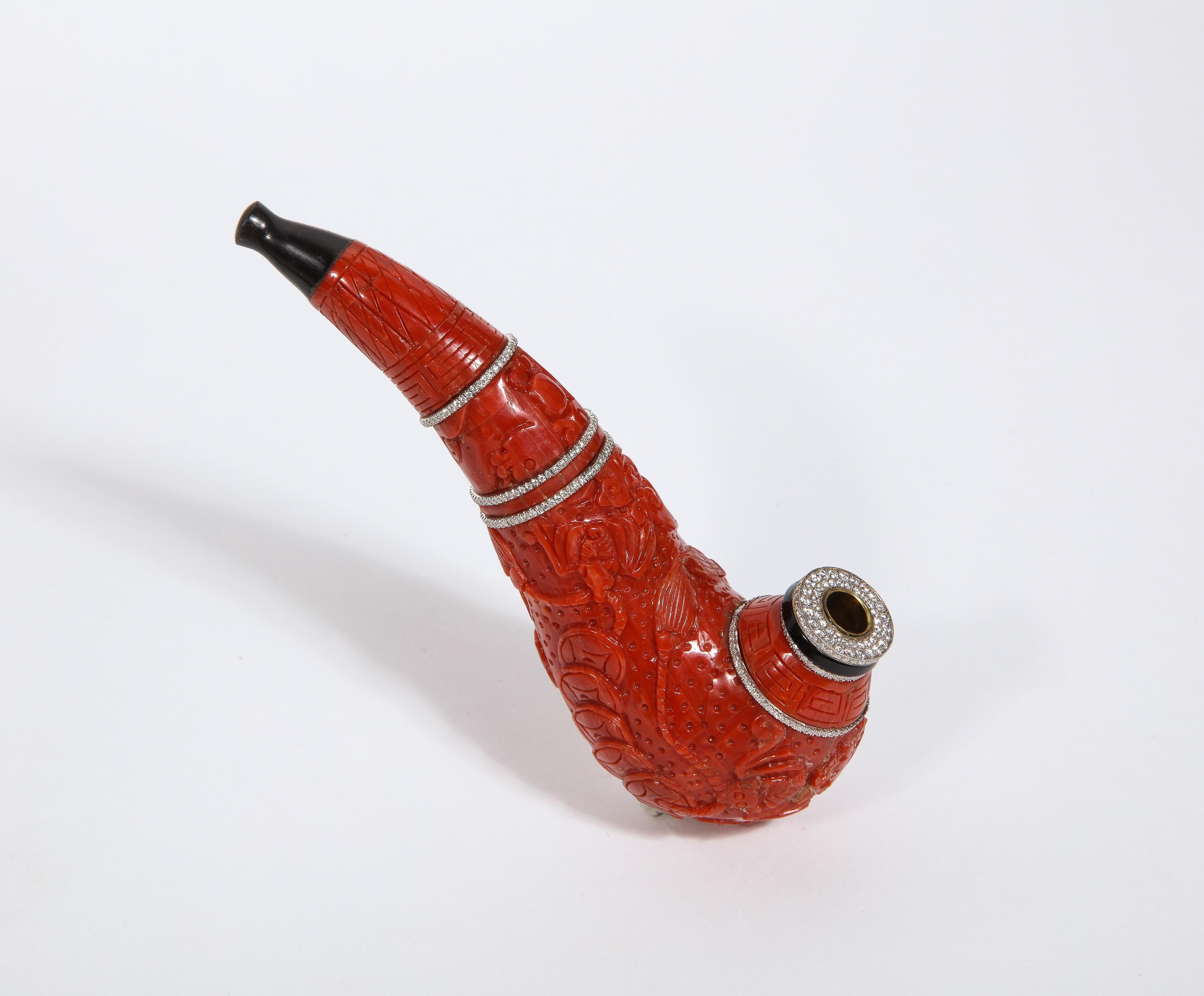 A contemporary coral, 18K gold, diamonds, and onyx pipe.

The carved coral pipe engraved with Chinese ornaments enhanced with brilliant-cut pave diamonds and onyx terminal, with an ebony mouth piece.

For a nearly identical piece, see Christies