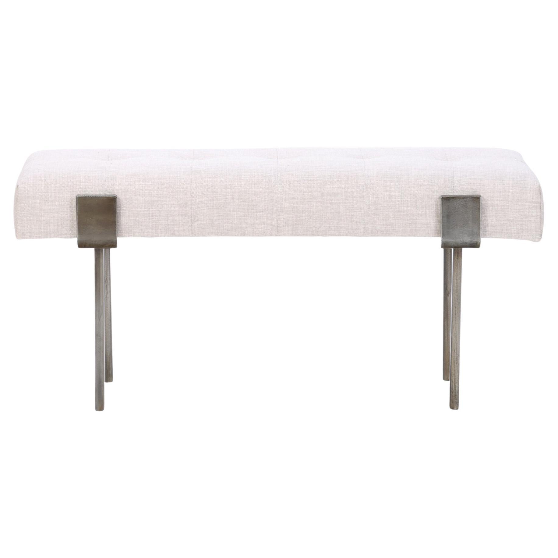 An upholstered iron bench with bronze patina wrap design. Contemporary