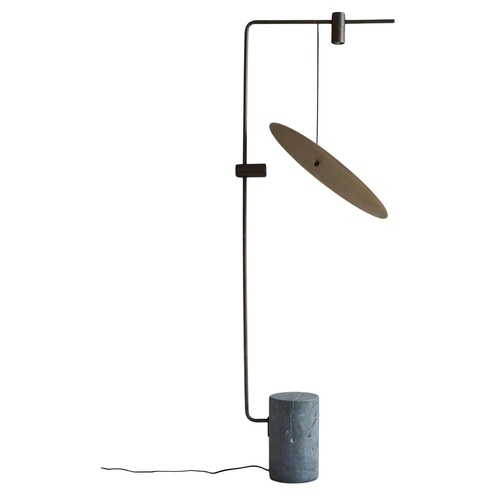 A Contemporary Iron and Brass Floor Lamp.