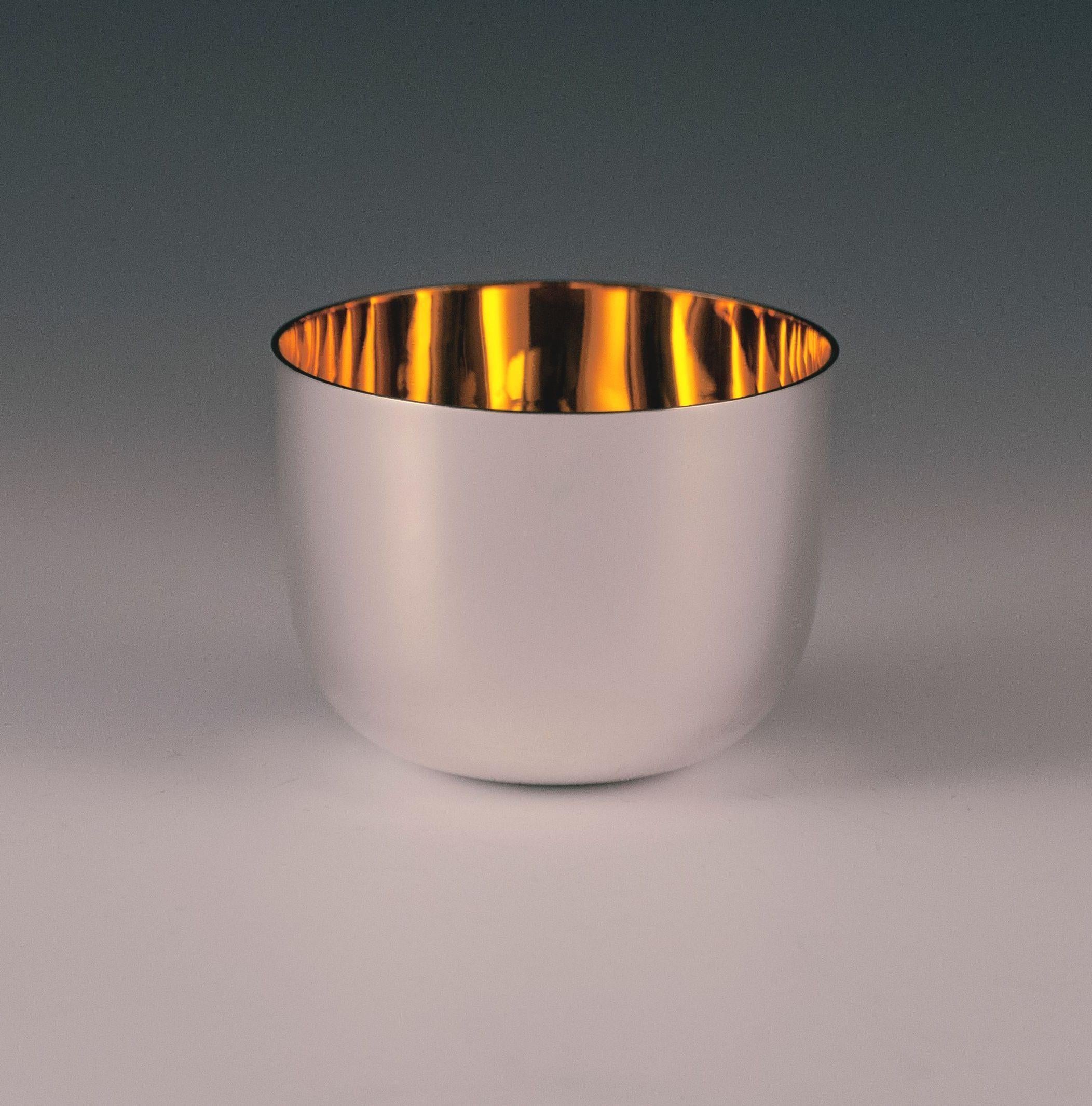 A Sterling silver tumbler cup / beaker, having a plain round body and a gold-gilt interior. Made in Sheffield in 2014. The dimensions of this Fine tumbler cup are height 2.25 inches 6 cm, diameter 3 inches 7.5 cm the tumbler cup would make a perfect