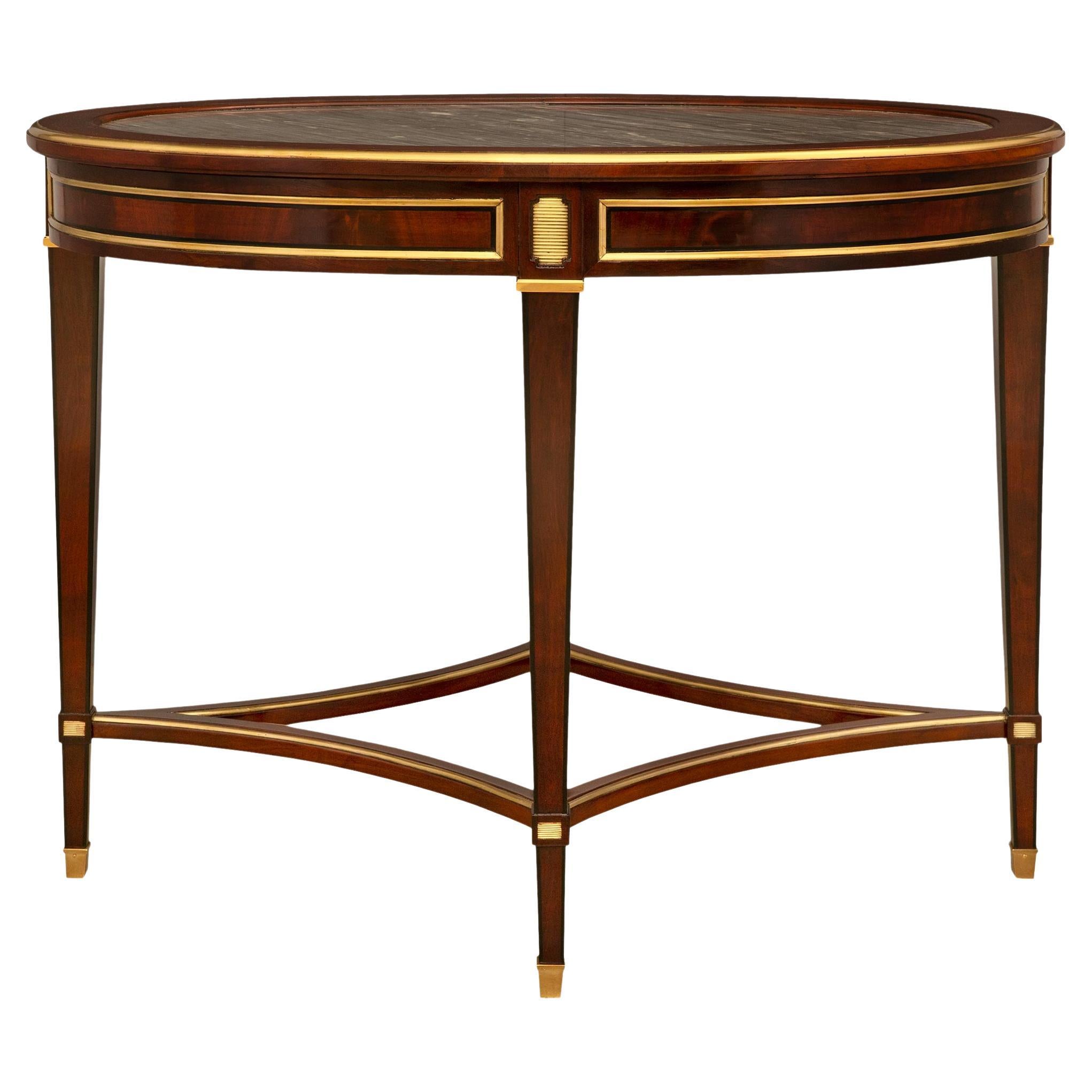A continental 19th century Directoire st. mahogany center table