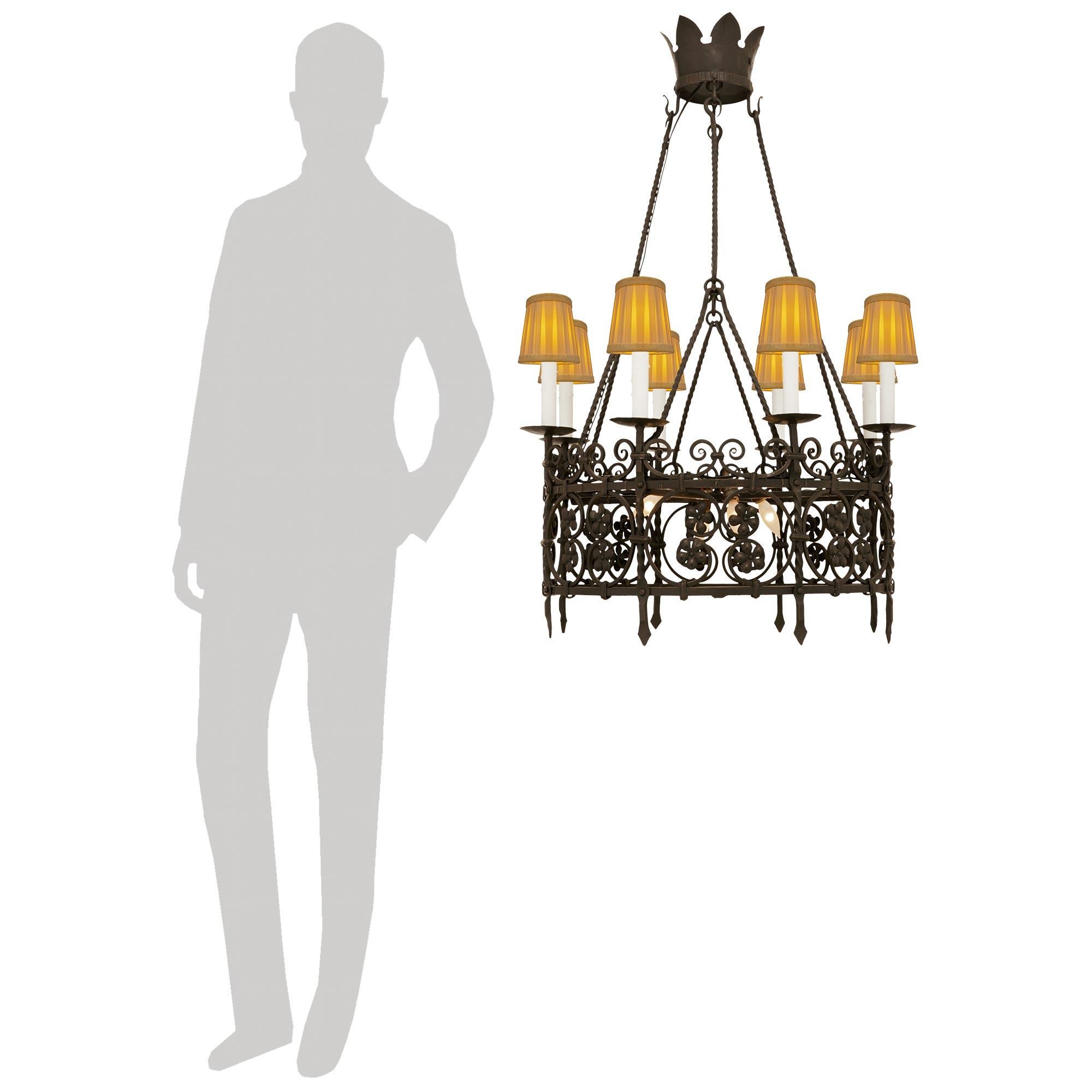 A handsome and most decorative Continental 19th century Renaissance st. Wrought Iron chandelier. The wonderful circular eight arm and twelve light chandelier displays an open cage with stunning scrolled Wrought Iron movements throughout. The bottom