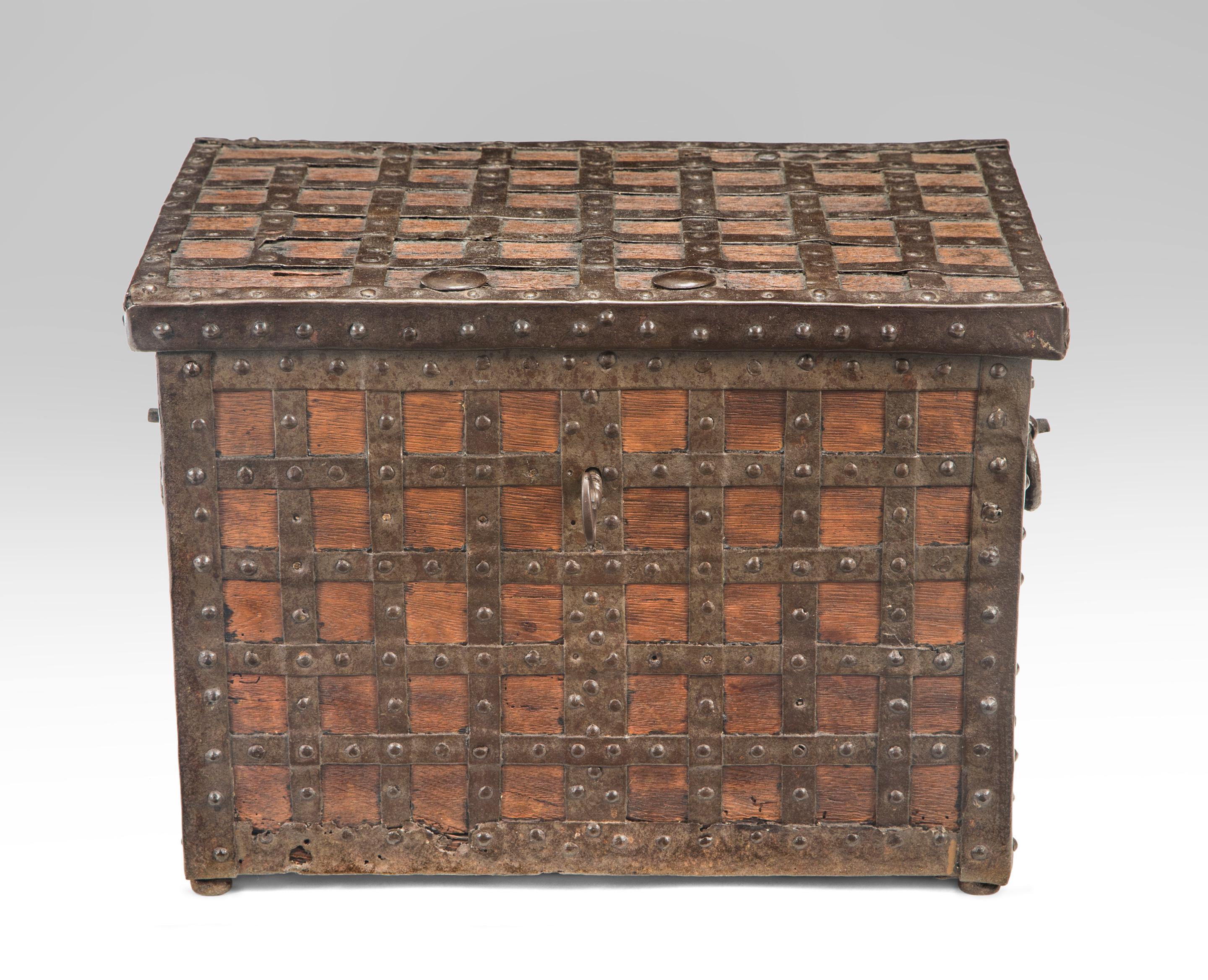 A continental Baroque trunk or strong box
circa 1700
A powerful box composed of wood overlaid with a grid of iron which not only strengthens the box but imparts a complex and serene style. The rectangular box mounted throughout with studded metal
