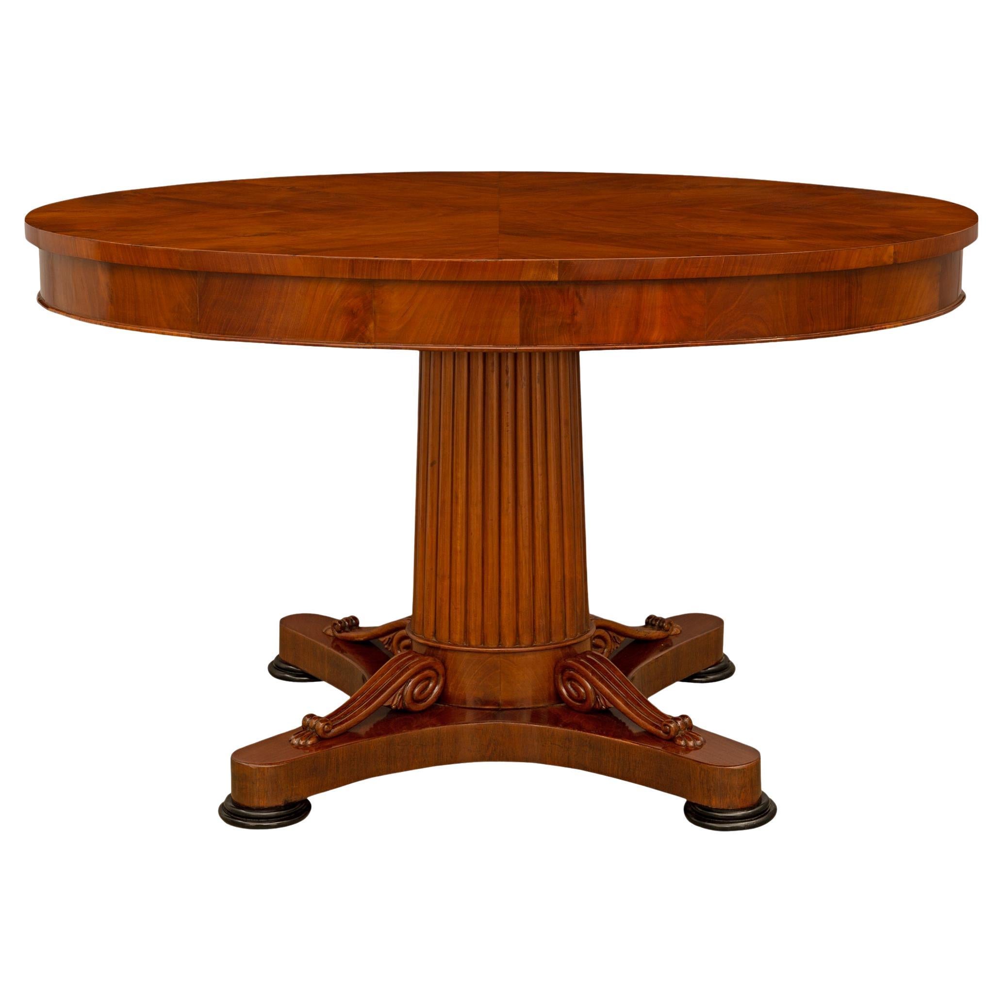 A Continental early 19th century Empire st. Mahogany Fruitwood center table