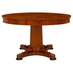 A Continental early 19th century Empire st. Mahogany Fruitwood center table