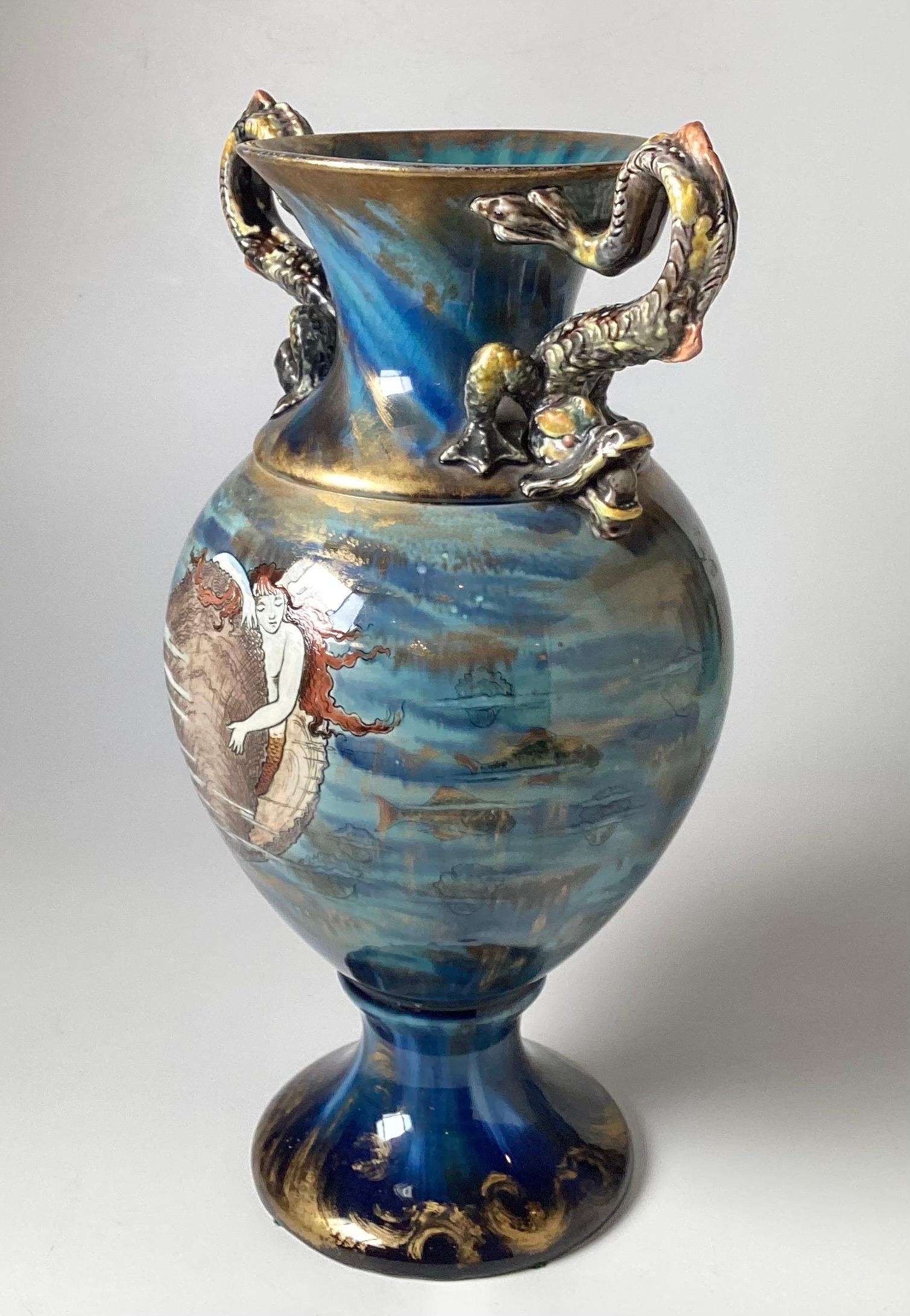 Striking hand painted aquatic themed vase with dragon handles. The design using Sqraffito technique featuring a mermaid, shell, lobster, fish in a beautiful high glaze in shades of blue, Art Nouveau style with a Japanese influence. European, 1898,