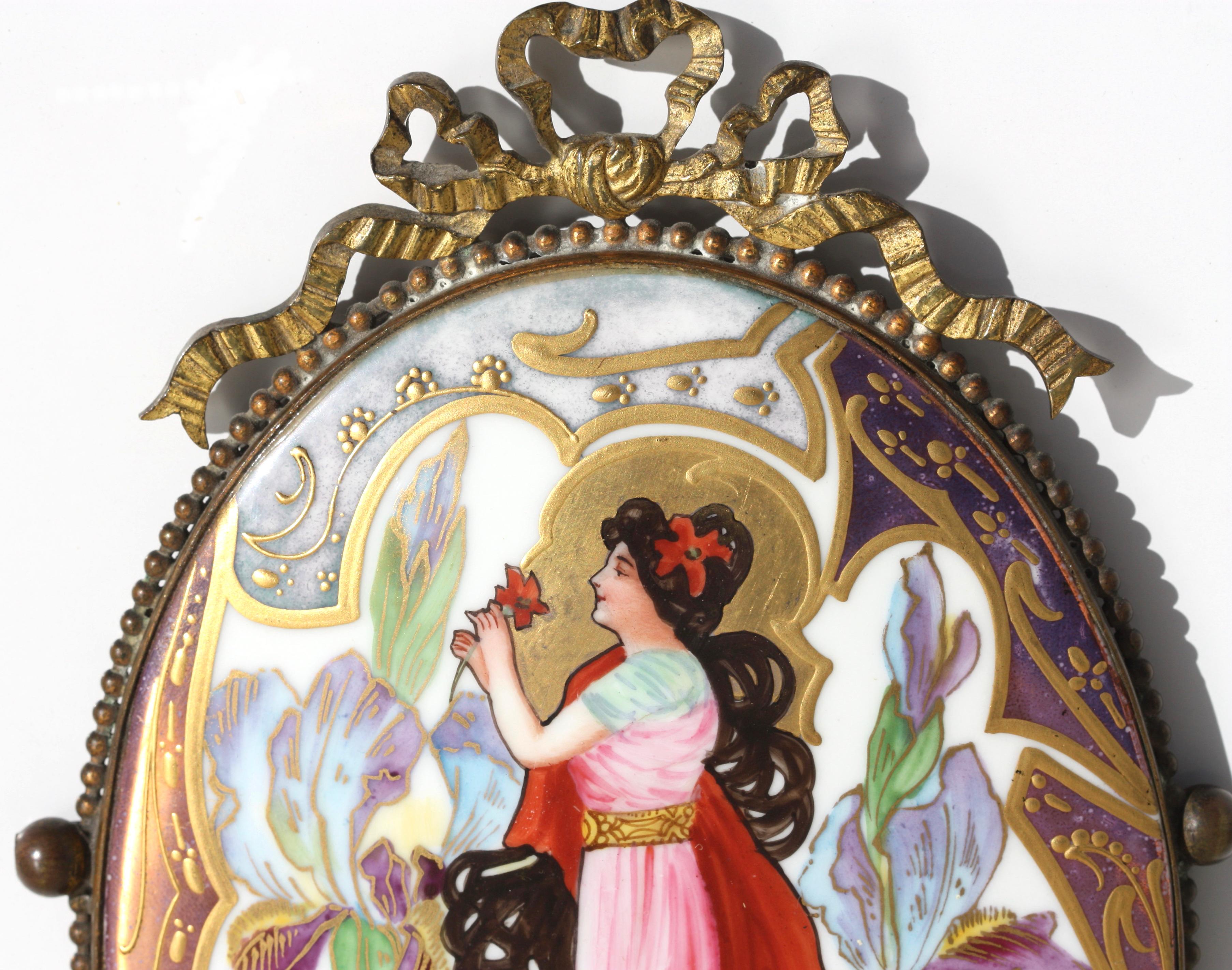 A Continental porcelain oval plaque
circa 1900
painted with a beauty holding a rose after Nathaniel SICHEL (1843-1907), impressed C above 170, within a gilt metal frame
Height 6.5 in. (17 cm.) 
Nathaniel Sichel (1843-1907) was a popular and