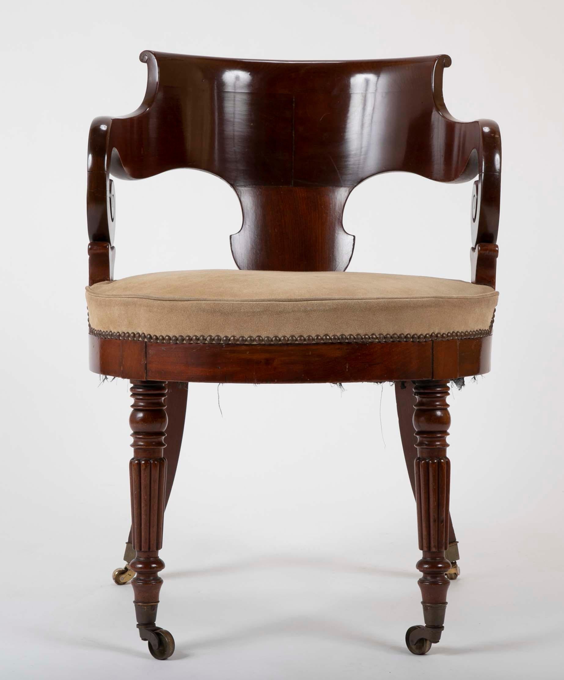 A Restauration period mahogany armchair with great lines and suede upholstery.