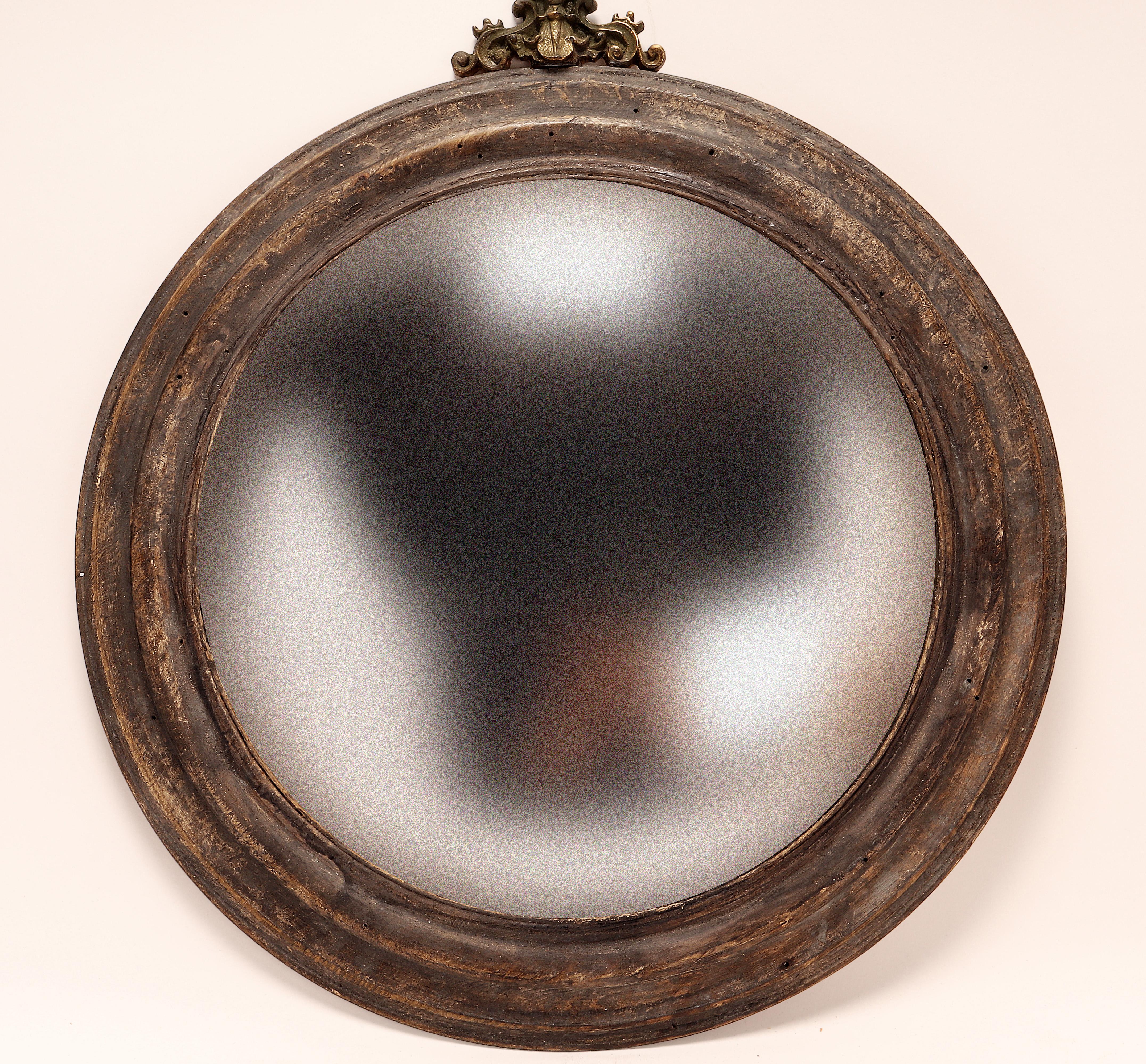 A Wunderkammer hanging round convex mirrors with gray wooden frame. Italy circa 1870.
